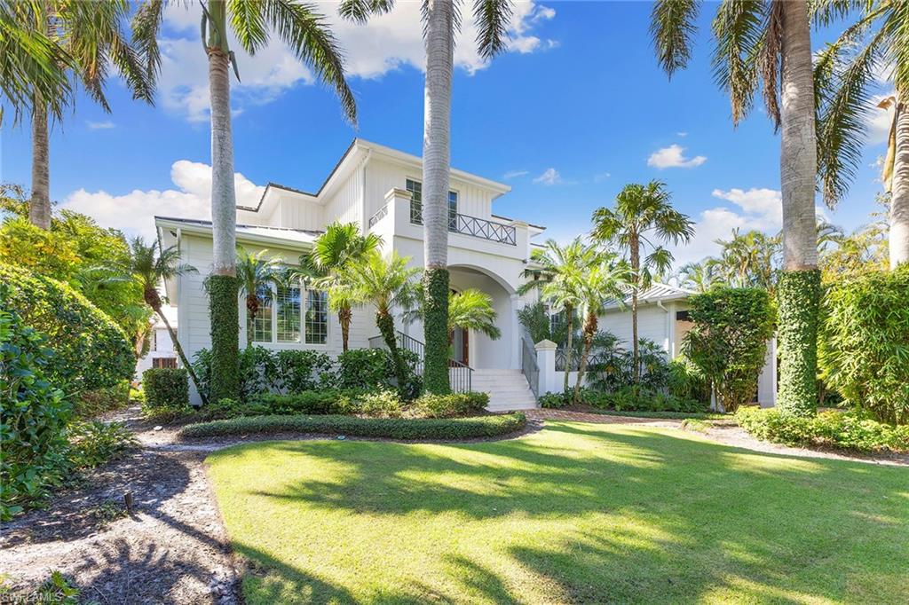 Experience the best of both worlds in this coastal home in Aqualane Shores, where unrestricted gulf-access boating meets the quiet luxury of Third Street South's shops and dining. The expansive 100-foot of dockage space provides ample space for an oversized vessel or multiple water toys. Just steps from the Naples Yacht Club, this residence offers the ideal balance of relaxation and adventure. Get a workout in the lap pool, or retreat to the private top-floor primary suite with a balcony overlooking Naples Bay. The spacious central living room features floor-to-ceiling sliders, creating an open, airy ambiance. The garage is equipped with built-in car lifts and an electric charging station, ideal for the modern car enthusiast. A fun and casual home that puts the best of Naples right at your doorstep.