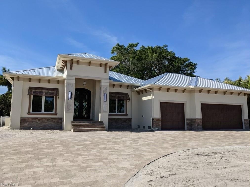 PARK SHORE -BRAND NEW SINGLE FAMILY HOME!!! Location, location, location!  This 3 bedroom plus den, 3 bath, over sized 3 car garage, oversize CIRCULAR Driveway, custom POOL, custom built beauty has it all. 40+ year STANDING SEAM METAL ROOF!! Walk to the Waterside Shops, to church or to the BEACH! With 2900 sq feet of living it's not too big nor too small. Built with quality and durability in mind. Be greeted by walking through a 10 foot decorative wrought iron door with impact glass into an open floor plan. Twelve foot high ceilings with custom designed coffered ceilings, over sized porcelain tile flooring, open the 10 foot continuous sliding doors to completely open the home onto the back lanai with a complete outdoor kitchen with a tranquil private pool setting under the palm trees.  Slip into the master bedroom with equally stunning design. Luxurious walk through shower and a soaking tub. The kitchen has Thermador appliances, offers electric and a gas ranges, and Kohler fixtures. This home is sure to satisfy the most discriminating buyer!