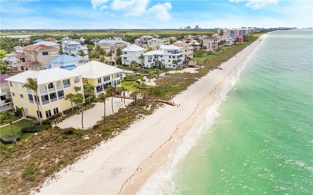 Most unique beachfront opportunity in Southwest Florida. Collier County’s Barefoot Beach, with only 22 direct beachfront single-family properties, offers a coveted costal lifestyle, superb views of the beautiful Gulf of Mexico and year round sunsets. The beachfront community of Barefoot Beach is situated on miles of sandy beach and features many amenities. The property offers 67’ feet of white sandy beach frontage and provides a tranquil setting complete with seasonal shore birds, sea turtle nests, and dolphins, accompanied by the sound of waves. Great-room floor-plan with tremendous open chef’s kitchen showcasing a large island, two refrigerators/freezer, three ovens and wine bar. Entertaining in the light-filled living room, dining room and kitchen space is a dream. The costal color scheme of the interior blends effortlessly with the soothing aqua of the Gulf. Lavish master suite features sliding glass doors that open to a wraparound balcony and panoramic Gulf views, plus four guest bedrooms and a media room. The residence has been recently updated with top quality finishes. (Note: Video and/or audio surveillance with recording capability may be in use on these premises.)