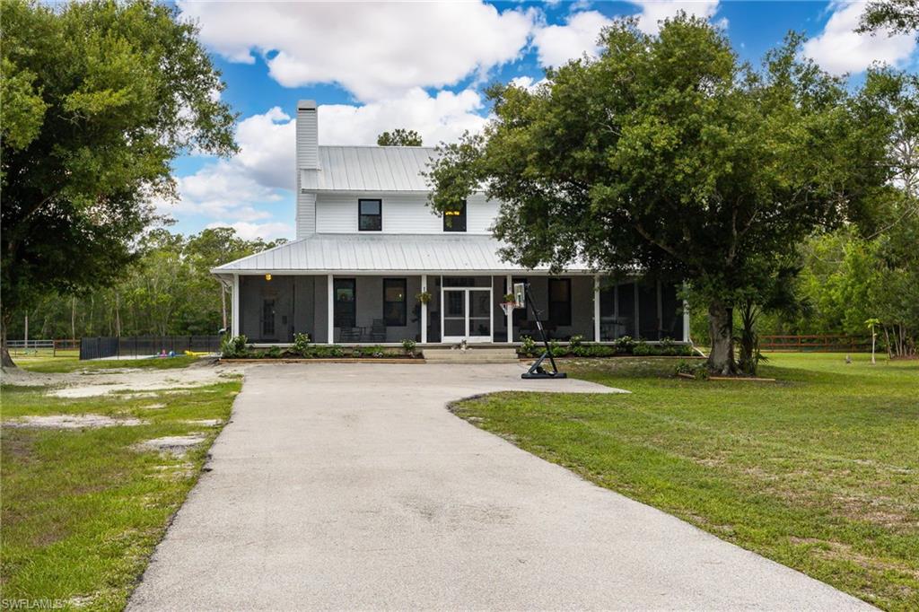 Southern charm meets country living on 5 beautifully fenced acres in one of North Fort Myers' most desirable acreage locations. Surrounded by majestic oak trees and lush landscaping, this impressive two-story residence offers the perfect blend of privacy, comfort, and convenience. From the moment you arrive, the inviting wraparound screened porch welcomes you home and provides the ideal place to relax while watching the children play, horses graze, or simply enjoying the peaceful country setting. Inside, the spacious 4-bedroom, 2.5-bath floor plan has been freshly updated with recently painted interior walls, creating a bright and welcoming atmosphere throughout. Outdoor living truly shines at this exceptional property. Cool off in the stunning 18' x 40' pavered resort-style pool, entertain guests beneath the stars, or unwind on the rear deck while taking in breathtaking Florida sunsets with your favorite evening beverage. The property is thoughtfully designed for both recreation and functionality. A large pole barn with a concrete floor offers endless possibilities for entertaining, storing your boat, housing equipment, or accommodating animals. A chicken coop, RV hookup, and abundant parking make this property ideal for those seeking space for all their toys, hobbies, and outdoor lifestyle.
Situated on a paved road and fully fenced, this property delivers the country lifestyle buyers dream about while remaining remarkably convenient. Located just minutes from I-75, Southwest Florida's two major airports, and directly across from Babcock Ranch's shopping, dining, and entertainment options, you'll enjoy the best of both worlds — peaceful acreage living with modern conveniences close at hand. Whether you're searching for a family estate, horse property, hobby farm, or simply a place to spread out and enjoy the Florida lifestyle, 11790 Fox Hill Road offers the rare opportunity to own a true Southern retreat with room to live, play, and grow.
