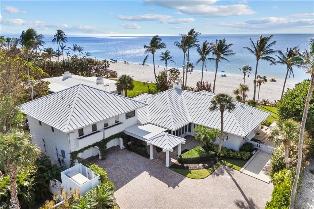 Exclusive Naples property featuring approximately 108 feet of direct beach frontage along the breathtaking Gulf of Mexico with private flag driveway entrance from 7th Avenue South. With approximately 4,249 square feet of total living space, this inviting cottage includes six bedrooms, seven full baths and a spacious two-car garage. The interior offers ample room for gathering and picturesque water views throughout. This is a rare opportunity to experience the quintessential beachfront lifestyle in a tranquil yet prime Old Naples location.
