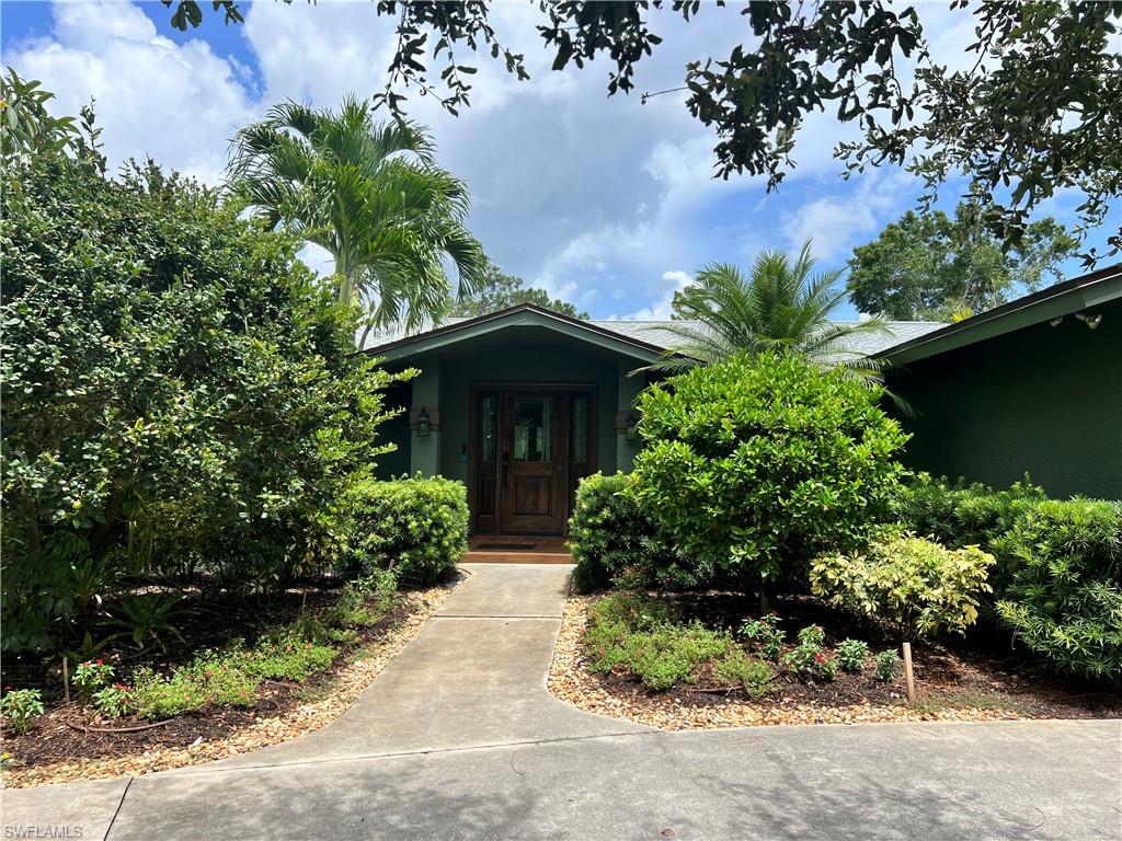 Lots of options with this beautifully landscaped property in prestigious Pine Ridge Estates!  Either tear down and build your dream home or enjoy this renovated property.  Main house features 4 bedrooms / 3.5 baths with updated floors, kitchens and baths.  Beautiful pool with hot tub, sun shelf, salt water chlorination and electric pool heater.  There is a separate building at the back of the property which hosts two individual 1bd/1ba guest apartments each with their own kitchen, screened lanai, HVAC system and separate entry.  A small laundry room with stack washer and dryer connects the two apartments.  On the other side of the guest house building is another 1bd/1ba loft apartment that can be used as a bonus room or an office.  The guest building is lushly landscaped and very private from the main house.  Rental opportunities abound!  There is also another garage /storage barn at the very back of the property for any additional tools or equipment that need to be under cover.  Fully fenced with electronic gate for pets and a baby gate around pool.  New roofs installed on both main and guest house building in 2021.  There is an entire home RO system and irrigation runs on well water.  Large backyard with resort style landscaping and lighting.