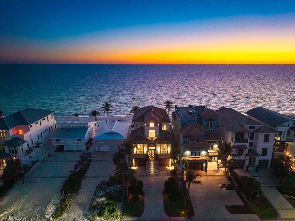 DIRECT GULF FRONT LIVING FEATURING BREATHTAKING SUNSETS, A PRIVATE POOL OASIS, AND STEP-OUT-THE-DOOR BEACH ACCESS! This 2018-built Potter Home is a coastal contemporary masterpiece that offers uninterrupted turquoise Gulf views and refined beachfront luxury at every turn. Designed with exceptional craftsmanship, the residence features solid concrete block construction, IMPACT GLASS, and electric storm shutters for lasting durability and peace of mind. The open-concept layout is ideal for entertaining, seamlessly extending through fully pocketing sliders to an elevated outdoor retreat complete with an infinity-edge pool and spa, summer kitchen, outdoor fireplace, and pool bath—all perfectly positioned to maximize panoramic water views and unforgettable sunsets. Spanning over 5,200 sq ft under air, the home offers 5 bedrooms, 5 full baths, 2 half baths, and a 6+ CAR GARAGE. The chef’s kitchen showcases an oversized quartz island, custom cabinetry, and premium appliances, while the primary suite serves as a private escape with expansive Gulf views, balcony access, and a spa-inspired bath with soaking tub and walk-in shower. Additional highlights include a private elevator, wet bar with wine fridge, dual new HVAC systems, motorized screens, and smart home integration. Ideally located near premier beachfront dining and upscale shopping, this residence delivers the ultimate in DIRECT BEACHFRONT LUXURY LIVING.