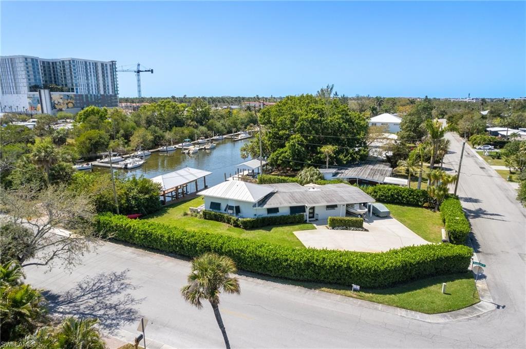 Income-Producing Waterfront Gem Near Downtown Naples. Seize this rare opportunity to own an income-producing, waterfront property just minutes from the heart of Naples! Nestled in the rapidly evolving Brookside community, this prime Gulf-access home has unobstructed canal views. With no HOA or rental restrictions, this is an ideal investment for short-term rentals or a luxurious personal retreat. Positioned in one of Naples’ most exciting redevelopment zones—including the Gateway Triangle, Metropolitan Naples, and the new 7-acre Brookside Marina—this property offers exceptional long-term value. The fully renovated home seamlessly blends modern elegance with coastal charm, featuring three bedrooms, three bathrooms, a chef’s kitchen with a gas Viking range, a Fisher & Paykel refrigerator, and exquisite quartzite countertops. For boating enthusiasts, the rare, grandfathered boathouse provides added protection for your vessel. At the same time, the private dock invites you to enjoy serene water views, spot wildlife, or head out for a sunset cruise. Just a short walk or bike ride away, you’ll find the world-class shopping, dining, and entertainment of 5th Avenue South, along with easy access to 3rd Street South, the iconic Naples Pier, and the city’s pristine sandy beaches. Whether you are seeking a lucrative rental investment or a stunning waterfront escape, this property delivers unmatched potential in one of Naples’ most sought-after neighborhoods. Act now—opportunities like this don’t last long!