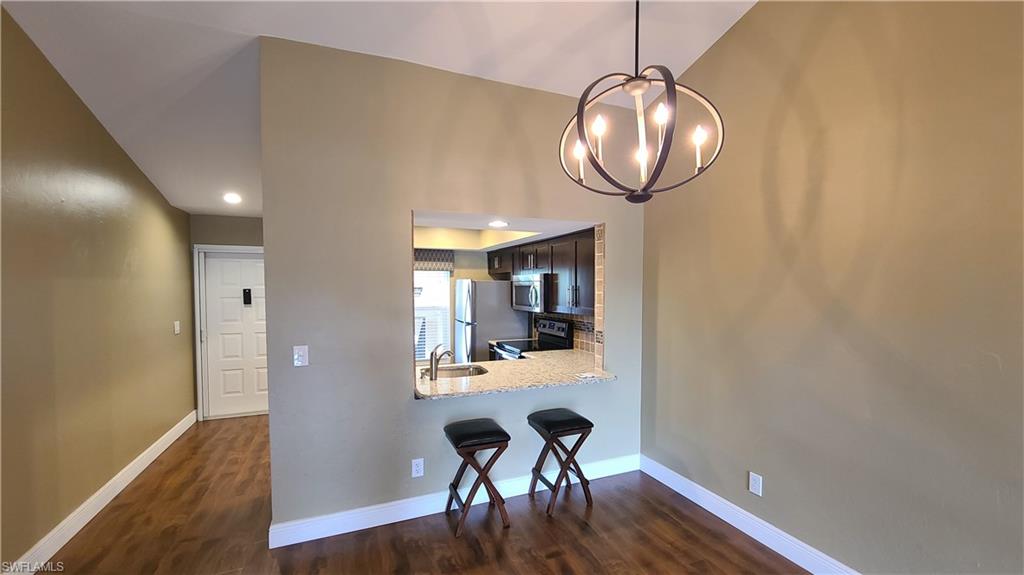 Beautiful move-in ready condo is waiting for you in sunny Florida! From the upgraded kitchen with stainless steel appliances to the IMPACT WINDOWS, this condo has everything you need. This 2nd floor unit has a private staircase and front porch. Screened lanai with lake view opens from the living room and master bedroom. Modern lighting, wood-look flooring throughout and digital thermostat are some of the upgrades in this unit. Electric/ remote control storm shutters. NEW AC 2019, water heater 2016. Washer and dryer in unit. Screened front door. Extra storage unit is located under the covered carport. Within walking distance to Lakes Park, this community features a central lake with fountains, 2 pools and spa, tennis courts, clubhouse and tropical landscaping. HOA fee includes cable and water.