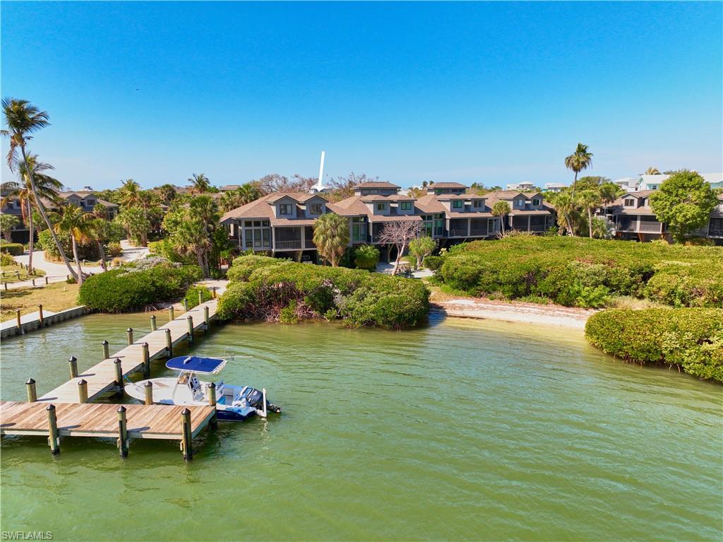 Priced to Sell!  Positioned directly on the harbor in Safety Harbor Club, this waterfront townhome offers one of the most convenient dockside locations on North Captiva Island. With the boat docks less than 50 feet from your door, this home is ideal for those who want immediate access to boating and waterfront living. The layout is designed to capture excellent harbor views while providing comfortable island living. Light-filled interior spaces flow naturally to the outdoor covered screen porch, where you can watch boats come and go and enjoy the serene waterfront setting.  As part of Safety Harbor Club, owners enjoy a full suite of amenities including a community pool, tennis & pickleball courts, clubhouse, on-site dining, & Gulf beach access. The nearby ferry landing makes travel simple while maintaining the peaceful, car-free charm of North Captiva. Whether used as a personal retreat or investment property, this harborfront townhome offers an exceptional combination of location, lifestyle, and boating convenience on one of Florida’s most unique barrier islands. There is a tenant currently in place until July 31, 2026.