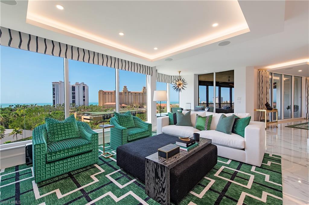 Sophisticated & stylish, with sunrises from the east and sunsets to the west, this sky home is simply splendid. Enter from your private elevator lobby and be wowed by its sleek porcelain floors, striking focal point fireplace and cheerful pops of color. Fully reconstructed by BCB Homes & expertly detailed by Renee Gaddis Interiors, 602 is perfectly positioned in the sought-after & recently renovated Trieste. Pristine & never occupied, this condominium includes a complete Lutron light & shade system, Sonos surround, luxury appliances & wine coolers, fixtures by Rohl, Kallista & more. The easy flowing floorplan offers a spacious great room with a dramatic back-lit wet bar, a clean line kitchen with thick Quartzite countertops & a morning room with a picture-perfect view. Relax in the primary suite finished with Mykonos European white oak floors, reverse tray-lit ceilings & a marble & granite master bath you must see to believe. All located within the one-of-a-kind gates of Bay Colony with its charming, meandering paver roads, & world class amenities including a private beach, dining and tennis club. This is your opportunity to be part of the true lifestyle experience that is Naples.