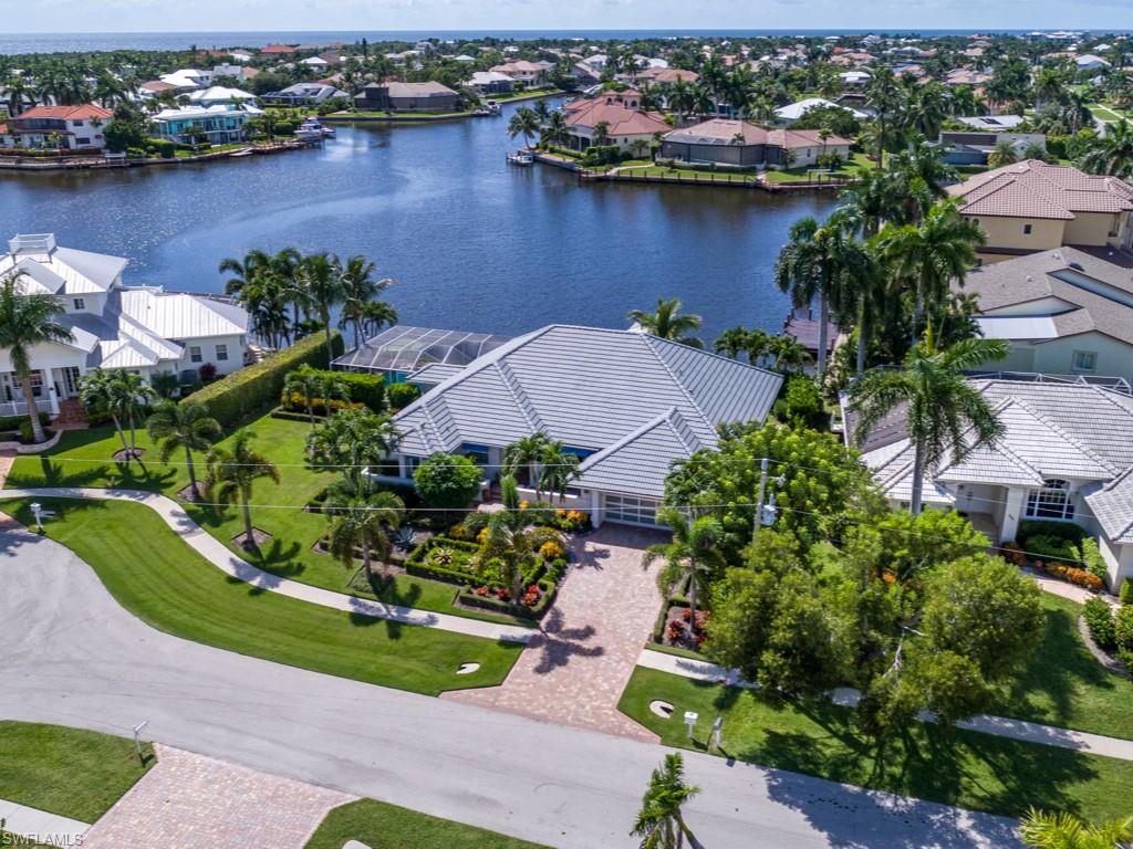 Here is a fabulous coastal contemporary residence at prestigious Clam Bay that was completely renovated & now it is absolutely stunning! Located in the highly desired Tigertail beach neighborhood, this meticulously maintained 3-bedroom home was intentionally re-designed to capture the expansive bay views & watercolor sky sunsets! All of the hard work has been done; it has an open floor plan, high ceilings, a great room design, an extraordinary gourmet kitchen with leather finish Cristallo quartzite, an open dining area garden side, an office overlooking the waterfront with a built-in desk and shelving, a bayside master bedroom suite with an incredible master bath and spacious closets, a wet bar area, guest bedroom quarters & an expansive lanai! Features include solid wood doors throughout, lavish cabinetry, vaulted ceilings, plantation shutters, all new fixtures, window coverings & California closets, new impact glass windows, new large span screens at the lanai, a new pool heater, a terrific new dock for avid boaters! This generous lot has 120’ of water frontage and to top it off, the landscaping design is unique and luxurious! Truly a rare find; a perfect Marco Island retreat!!