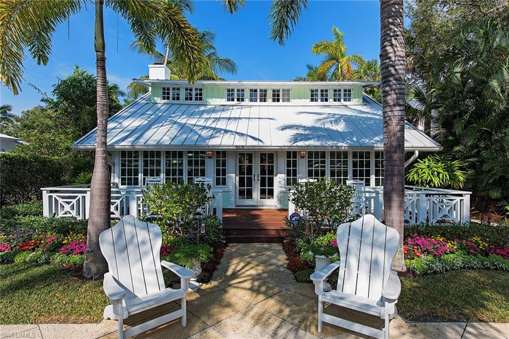 When tasteful renovations are completed while maintaining the charm and character of an original Old Naples cottage, a truly special property exists. Surrounded by beautiful gardens, Royal Palm trees and picture-perfect decks and patios, this adorable cottage also features a separate guesthouse. Home to a living room with a wet bar, a bedroom and a full bathroom, the guesthouse creates a desirable amenity that is hard to find in Old Naples. Ideally located, the cottage sits just two blocks from the Gulf of Mexico and three blocks to the heart of Third Street South and a long list of wonderful galleries, boutiques and restaurants. The home itself is perhaps highlighted by the open floor plan which blends the family room and dining area into the updated kitchen which is complete with commercial stainless steel appliances and vintage, hand-made, fully restored cabinetry.  Rooms are filled with natural light and accented with oak floors, white panel walls and charming ceiling details. The pool and spa primarily benefit from western exposure and are just as charming as the interior.