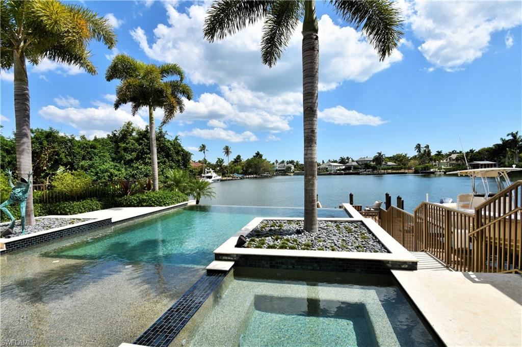 Elite waterfront "bridge-free" location with spectacular Southern exposure offering panoramic vistas fronting the broad waters of Aqua Cove.  It is just 9 homes from the beach and 2 blocks from 3rd St. S. bistros!  This exquisite coastal sleek superbly crafted ultra custom quality residence is on 161 pilings.  It offers opulent interior appointments while retaining an unpretentious warm casual elegance!  Herein. . .a fusion of outdoor / indoor living enhanced by extraordinary entertainment areas.  Dramatic Infinity edge pool & spa.  Boat slip:  44 ft. - room for 50 ft. dockage.  ** 2014 "New Construction Sand Dollar Award Winner"**