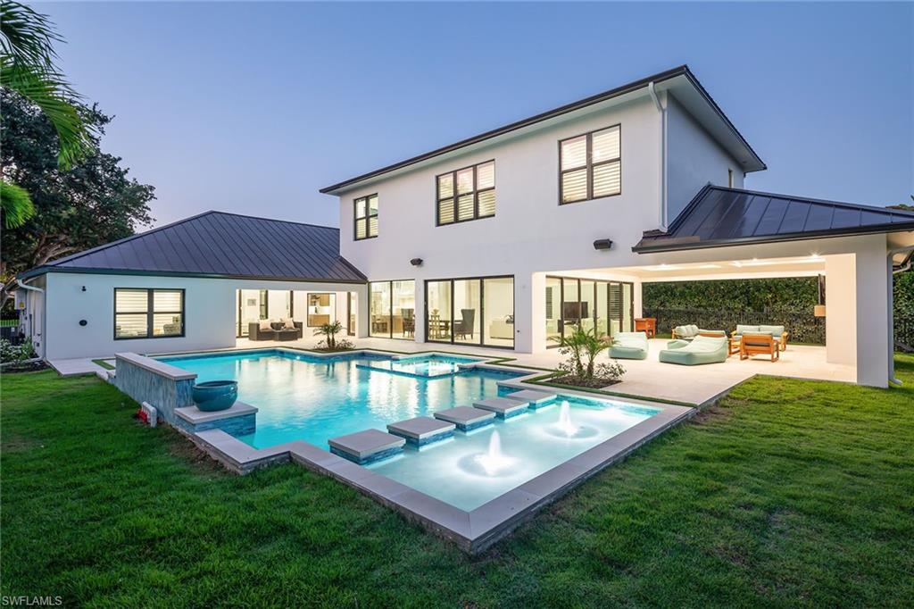 Sophisticated and never available new construction in Monterey completed in 2024 with the highest quality finishes throughout this sprawling 4,216-square-foot five-bedroom plus study and bonus room home with 7,838 square feet of total living space. Enjoy the sunny southern exposure and open layout with seamless flow for family time or entertaining to the spectacular lanai through the 14 sliding doors. Architectural details include Marvin Bronze impact windows and sliders, bronze metal roof, custom ventless exterior gas fireplace, beamed ceilings inside and out, Italian French white oak flooring, Italian Calacatta marble main bath, stylish custom marble in guest baths and gorgeous large format porcelain tile flooring in main living area. Sleek white oak staircase with LED step lights to the upstairs bonus room and three guest bedrooms. Large cook’s kitchen with six-burner Wolf gas stove, white shaker cabinetry and gleaming quartzite counters. Countless features include upstairs and downstairs laundry rooms, with second refrigerator and gas dryer in main laundry room, 500-gallon propane tank, two on-demand gas hot water heaters, California Closets, garage built-ins, wood Bahama plantation shutters, a fenced backyard, Sonos system with four zones and Wi-Fi extenders, and spray foam insulation in attic and between floors joists for soundproofing. The stunning custom 40-by-20-foot pool is ideal for lap swimming or family fun with the oversize spa and sun shelf and multiple water features. New construction was completed with certificate of occupancy in 2024 after the original 2,250-square-foot home was taken down to the block walls. Monterey continues to be among the leading family communities in Naples conveniently just three miles to Vanderbilt Beach and two miles to Mercato and Waterside Shops with 24-hour guarded gatehouse. Excellent amenities include award-winning clubhouse for private events, fitness center, heated lap pool, Har-Tru tennis courts with active tennis programs and pro play area, and basketball/pickleball court. A-rated public schools and three excellent private schools nearby.