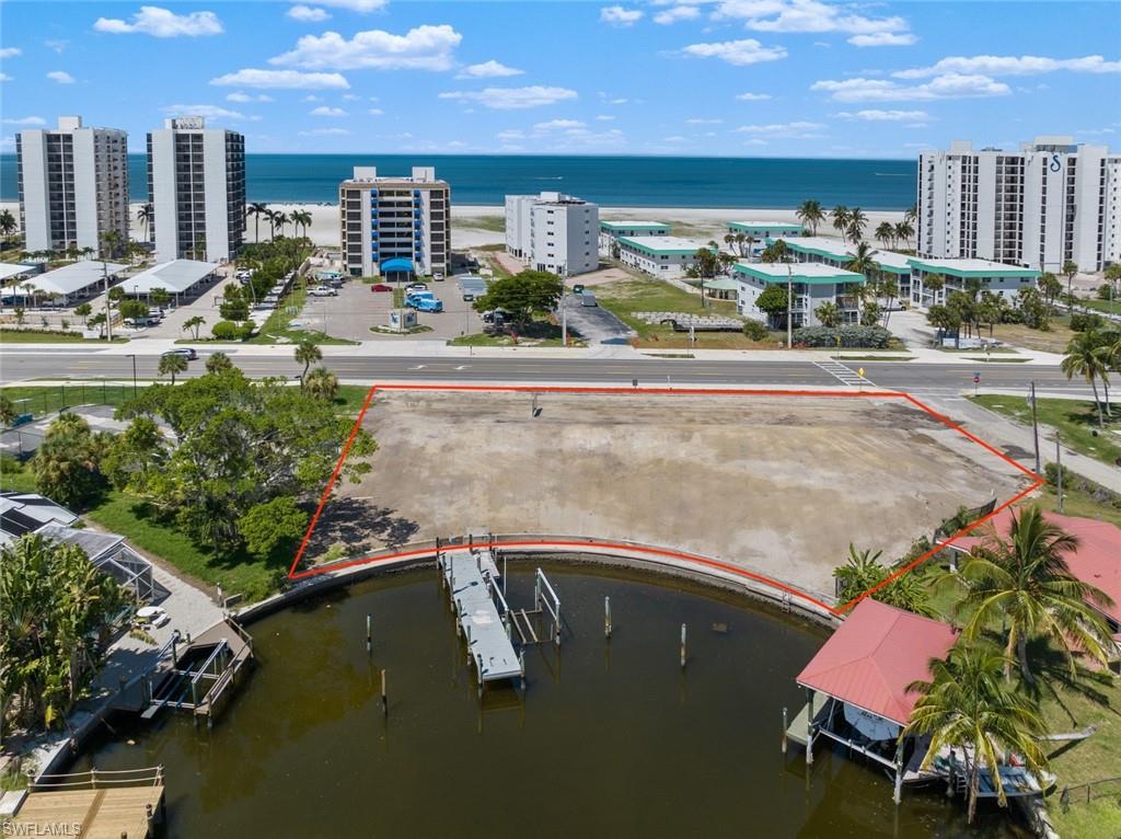 Unveil the transformative potential of the Dolphin Inn Resort, a once-thriving 22-room hotel now poised for a new chapter. Perfectly situated on a gulf access canal and directly across the street from the breathtakingly beautiful Fort Myers Beach, this property is a gem waiting to be reimagined.

The Dolphin Inn Resort presents a rare and exciting opportunity for visionary developers and investors. With its prime location and ample space, you have the freedom to shape the future of this property according to your dreams. 
* Design and rebuild a 22-room hotel into an exquisite boutique retreat that captures the charm and allure of coastal living. Design guest rooms that create a unique and memorable experience for guests, with modern amenities and stylish touches that reflect the essence of beachside elegance.
* Develop a new 13-unit condominium building that caters to those seeking a luxurious and permanent slice of paradise. Design spacious residences with panoramic views, upscale finishes, and direct access to the Gulf of Mexico, offering an unparalleled coastal lifestyle.

Embrace the redevelopment of Fort Myers Beach with the Dolphin Inn Resort’s enviable location. Situated on a Gulf Access lot and just steps away from the pristine white sandy shores, residents and guests can immerse themselves in sun-soaked days and stunning sunsets or a casual and relaxing boat excursion. Enjoy the convenience of having the beach and all its recreational opportunities right at your doorstep!