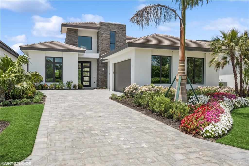 Introducing the exquisite custom Costa Rio, a masterpiece of modern living available in Messina at Miromar Lakes. 3,523 SQ FT. of Living area. Boasting three bedrooms, three and a half bathrooms, a Covered Balcony, a Lanai, the expansive great room and den, plus a bonus room, provides versatile areas for relaxation and entertainment. At the same time, the three-car garage ensures convenience and ample storage. A dramatic transitional-style front elevation, adorned with stone veneer, sets a captivating tone, inviting guests into a world of luxury. What truly sets this home apart is its innovative design, featuring an abundance of glass to flood every corner with natural light, enhancing both the ambiance and the home's unique curb appeal.