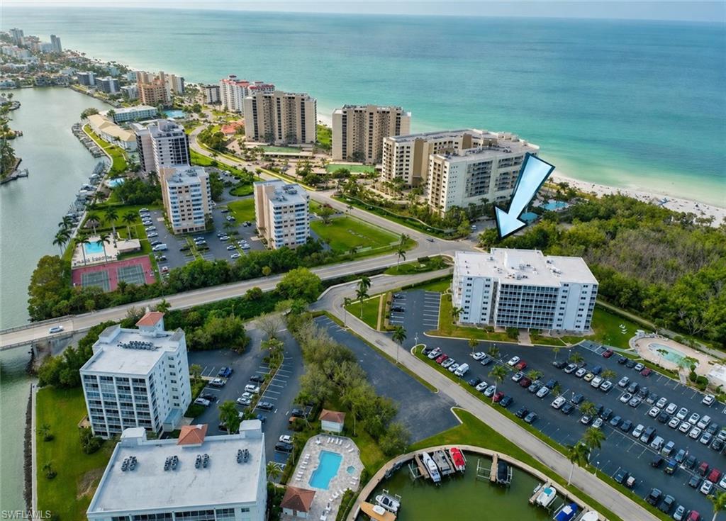 AVAILABLE FOR SEASON 2027! Wake up steps from the soft white sands of beautiful Vanderbilt Beach, one of Naples most coveted winter destinations.  From your screened-in fourth-floor balcony, enjoy the gentle breezes in a perfect setting for quiet mornings, sunset evenings, and effortless relaxation.  Inside, the condo feels fresh and modern with quartz countertops, stylish tile flooring, a glass-enclosed shower, and a modern coastal décor that makes you feel instantly at home. The open layout includes a queen bed, full-size sleeper sofa for guests, breakfast bar, dedicated workspace, fully equipped kitchen with stainless appliances, and extra storage space — ideal for an extended stay or a winter escape.

What truly sets this location apart is the lifestyle. Nestled on Baker Carroll Point and bordering the breathtaking Delnor-Wiggins Pass State Park, you’ll have direct access to one of America’s top-ranked beaches. Spend your days swimming in turquoise waters, strolling along the shoreline, spotting dolphins, or simply soaking up the Florida sunshine. Unwind at the heated pool or enjoy a casual evening at the outdoor grilling area surrounded by the natural beauty of Southwest Florida.  Within walking distance are iconic Naples favorites such as The Turtle Club, La Playa, and the Ritz-Carlton for unforgettable beachfront dining and sunset cocktails. When you’re ready to explore, Mercato, Waterside Shops, Venetian Village, and downtown Naples are all within easy reach. This is the perfect blend of comfort, convenience, and coastal elegance for that unforgettable -- and budget-friendly -- Naples beach getaway!
