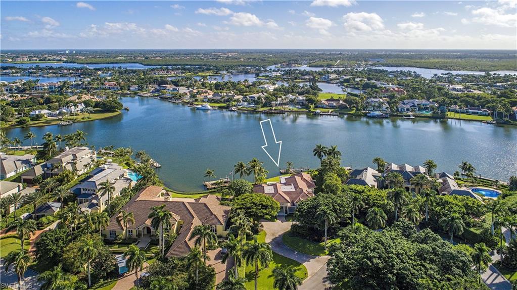 H.241 - Positively wonderful, expansive water views at the widest part of Man-O'-War Cove! Oversized lot has approximately 141 ft. of waterfrontage and boasts 29,219 sq. ft. for your future dream home. Just a short distance to the prestigious Port Royal Club on the beach for world-class dining, tennis and fitness facilities, with immediate membership eligibility. Direct Gulf access from your private dock. Charming older home is being sold "AS-IS".
