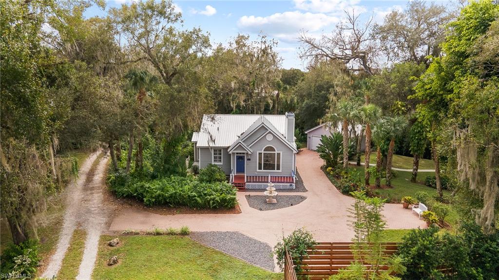 River Access Home!  Located in the city of LaBelle, nestled under the old Florida live oaks and surrounded by mature landscaping with brick patio and walkways.  This home offers vaulted ceilings, wood burning fireplace and picturesque view of the river from the family room.  Master suite with access to screened lanai provides walk in closet and renovated bathroom with sunken jet tub and separate shower.  Full lower level basement is perfect for recreational game room, family room and adds safe haven for storms.  Detached garage, whole house generator, dual AC system and metal roof.  Enjoy beautiful river view from front deck and the serene sounds of nature from the rear screened lanai.  Property is irregular shape with approximately 20' of river frontage. Call today to schedule a private showing.