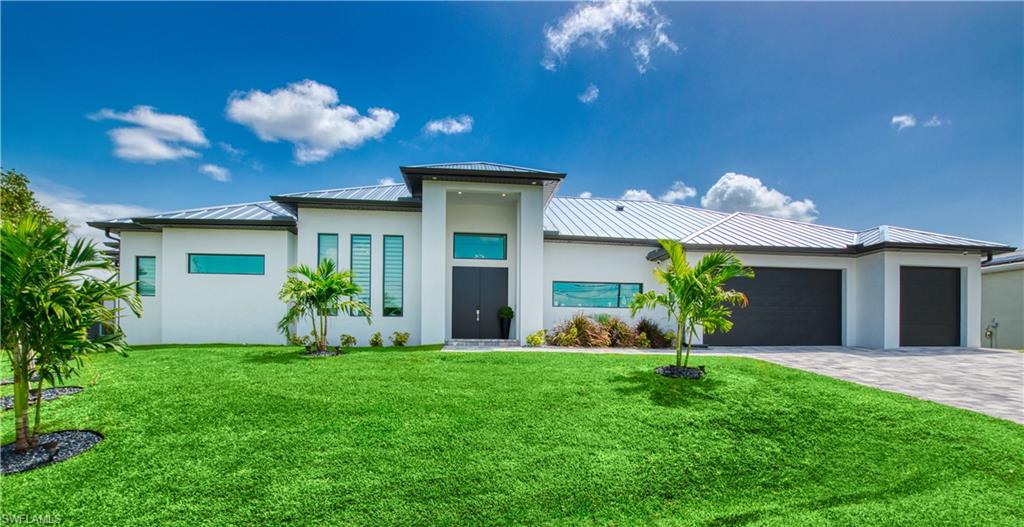 Welcome To This Rare Waterfront Masterpiece on a cul-de-sac in one of Cape Coral's most desirable neighborhoods just off Surfside Blvd. Built in 2023 this south exposure turnkey dream escape boasts 3,245 sq ft of living area with all 4 spacious bedrooms enjoying the fantastic water views. 155’ of water frontage with a raised 10’ seawall accommodate a composite decking captain’s walk across with a 30’ boat slip and 16,000 lbs. lift with water and electricity, a 15’x10’ Tiki Hut and kayak platform. The outdoor space is nothing less than outstanding: an all-day sun flooded 103’ wide pool deck surrounded by a panoramic screen enclosure covering a 58’ long gas-heated saltwater pool and spa with 2 sun ledges and a rock pit as well as a hot/cold shower and plenty of lounge chair space including a separate pool bathroom and an additional room for a future sauna or simply storage. The 47’ wide covered terrace features a BULL summer kitchen with granite countertop, active hood, fridge, sink and trash can. The grill is supplied with propane gas by a 1,100 gal buried gas tank also serving the tankless water heater, pool heater, future fire pit and fireplace on the lanai. While the house has impact windows and doors, the lanai area can be protected by just lowering the massive Kevlar screens. Walking inside through the expansive sliders the seamless indoor-outdoor flow becomes clear. Lots of natural light, 13’ ceilings paired with tray ceilings up to 15’ generate lots of volume. The kitchen is outfitted with premium LG appliances and a wine rack and quartz countertops covering the breakfast bar and the island waterfall dining table. The open den area, the living room, kitchen and all 4 bedrooms have prime views of the pool deck and the 130’ wide Albenga canal. The oversized primary suite is a retreat, showcasing a tray ceiling, his-and-hers closets, lanai access and fantastic views as well as a modern double vanity bathroom with quartz, a standalone tub and a huge walk-in shower. The 3 guest bedrooms all feature their own ensuite bathrooms with quartz countertops and different themes as well as spacious closets. The home is equipped with Italian floor tiles, premium cabinets, 3 air conditioning units, a Sonos sound system, a 5-camera system with monitor, smart TVs, security system, and modern lighting as well as a 3rd separated garage. The laundry room accommodates the washer, dryer, additional storage space, floor cabinets with sink and the structured wiring wall box. Enjoy the finest lifestyle with boating, fishing, golfing, shopping, airports, islands and beaches. You are entertaining guests or unwinding after a long day? This home’s outdoor oasis delivers the ultimate Florida experience. Whether you're looking for a private estate or a luxury vacation rental, this wonderfully crafted home with attention to detail and modern finishes offers it all and is ideal for an occupant or investor, seeking an elite retreat in the Southwest Florida paradise.
