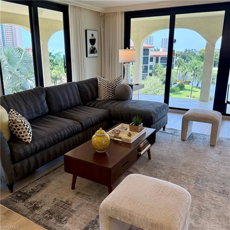 Enjoy sweeping panoramic views from this spacious top-floor corner residence in the desirable Chateaumere community of prestigious Pelican Bay. This beautifully updated 2BR, 2BA condominium is filled with natural light and offers an open, inviting floor plan designed for comfortable living and entertaining. The large wraparound lanai is a big WOW factor. Stylish updates throughout are complemented by brand-new designer furnishings, making this residence truly turnkey. New wood tile floors throughout. The corner location provides added privacy and expansive views from multiple exposures, creating a bright, airy atmosphere. Chateaumere offers beautifully landscaped grounds, pools, spa, fitness, a community room, guest suite and more. Convenient location to the Commons and South Beach tram station. Pelican Bay residents enjoy exclusive private beach access with beachfront dining, miles of walking and biking paths, state-of-the-art fitness center, tennis, pickle ball and close proximity to Waterside Shops, Artis–Naples, Mercato, and Naples' finest dining and entertainment. Luxury, location, and lifestyle await.