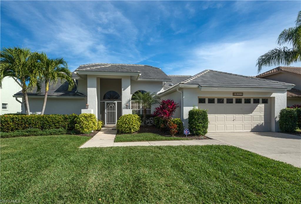 A fantastic home in a fantastic place!  Located in the secure Kelly Greens Golf & Country Club Community and backing to the 4th tee this truly lovely home awaits you.  Newly painted inside and out in a soft color palette the home is light, bright and open with vaulted ceilings.  From the foyer walk into a large living room with a disappearing door wall overlooking the lanai and pool.  An elegant dining room finishes the space before entering the very large kitchen with expansive granite surfaces on all counters and the center island.  The kitchen overlooks the beautiful lanai via a large pass through window while keeping the family room complete with ample seating, gas fireplace, bar and bay window in view.  Many updates abound in this home including new AC (2016), new tile and carpeting in 2015 & 2016.  The pool cage also new in 2016, features heavy construction support bars with top line UV protective screening.  This home is set for resort style living with multiple community amenities featuring championship golf, Green fees are included in the HOA fees, tennis, swimming pools, dining and banquet centers, close to Sanibel Island and Fort Myers Beach!  Come see it today!