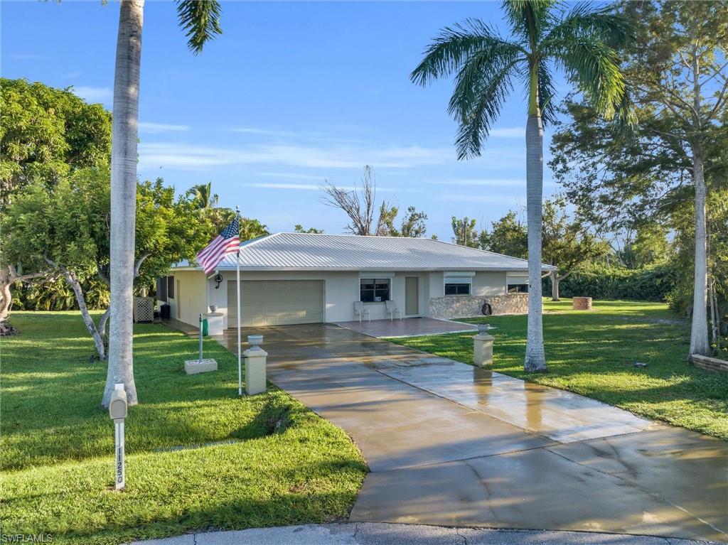 Being only 10minutes or less away from both Fort Myers & Bunche beach, and within 15 minutes of both Sanibel Island & Cape Coral- this is the perfect home for those looking to enjoy all that Southwest Florida has to offer.This beautifully classic single story ranch home with a welcoming open layout offers 3 spacious bedrooms, 3 bathrooms. Two large updated showers for the main & guest bedrooms with a 3rd shower next to the incredible personal steam room.All connected by a stunningly large kitchen and foyer.The extra large Florida room looks out to the backyard with a rear footage of 157' .Which has a wishing well and private dock on the community pond.Connected to the Florida room is a covered and glassed-in lanai which has a true in-ground jacuzzi giving this home an exquisitely unique feature.The home also boasts an attached 2 car garage, with attic access, and a new water heater 2023.The exterior of the home has a new metal roof 2023, aluminum gutters 2023  and an 2019 ac unit which was rebuilt in 2023.This house also has hurricane shutters and a spacious storage shed along the backside wall.This stunning home is in a pristine location, sitting on a oversized corner lot.