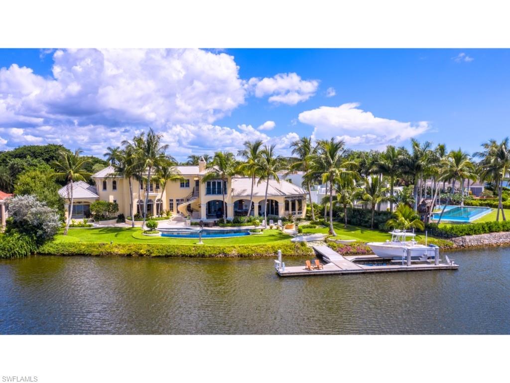 An exciting opportunity has reappeared! Situated on a large lot and one half, this exquisite estate has panoramic views over the wide waters of Galleon Cove, a most sought after location within Port Royal. Superb taste is manifested throughout with remarkably detailed elements of stonework and rich wood. Creatively designed by Harrell & Co. Architects - Florida, Inc. and built by BCB Homes, Inc., the home’s numerous “shore parallel” rooms take full advantage of the exceptional western views from this unique waterfront setting. Approximately 207 feet of water frontage per the plat and/or deed. The casual rooms, detailed with the same level of intricate craftsmanship as the great rooms, welcome comfortable retreats, dining, and entertaining both inside and outside. Impressive master suite is accompanied by 4 guest bedrooms in the main residence and a "self-sufficient" 5th guest suite with its own exterior entry. The meticulously maintained residence offers 6 garage bays and large motor court. Elegant grounds and verdant landscaping are complimented by a significant concrete floating dock and lift. Port Royal Club membership eligibility. Residence is no longer furnished.