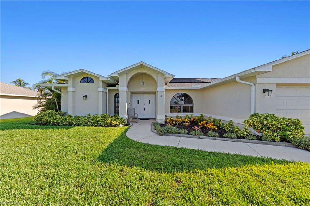 Discover affordable waterfront living in southwest Florida! Nestled on a freshwater canal just moments from the edge of Mohave Lake, this well-maintained 3-bedroom, 2-bath home with 2-car garage offers the perfect blend of comfort, functionality and Florida outdoor living. 

 Southwest Cape Coral location provides convenient access to shopping, dining, schools, medical facilities and entertainment, while still maintaining the serenity of a residential neighborhood. Hurricane shutters and a NON-FLOOD ZONE add peace of mind. 

Inside is an inviting layout with recent updates that include recessed and pendant lighting in the kitchen, along with new LVP flooring in both guest bedrooms. The spacious kitchen is is designed for everyday living, offering abundant solid wood cabinetry, pantry and plenty of workspace.

Four sets of sliding glass doors open to an attractive PebbleTec lanai deck and solar heated pool. Sliders pocket to create a seamless indoor-outdoor living experience.  The primary bedroom features two generous walk-in closets.

The back of the property features a concrete seawall and dock, making it easy to fish, kayak or simply relax and enjoy the tranquil view. Mature mango and avocado trees provide delicious homegrown fruit, while a fragrant jasmine tree fills the air with a delightful aroma. Fresh front landscaping enhances the home's curb appeal, and a working irrigation system keeps the yard lush year round. The garage features built-in cabinetry and workspace for hobbies, projects or additional storage.

Whether you're looking for a full-time residence, seasonal getaway or waterfront investment opportunity, this affordable Cape Coral gem delivers exceptional value and the relaxed Florida lifestyle you've been searching for!