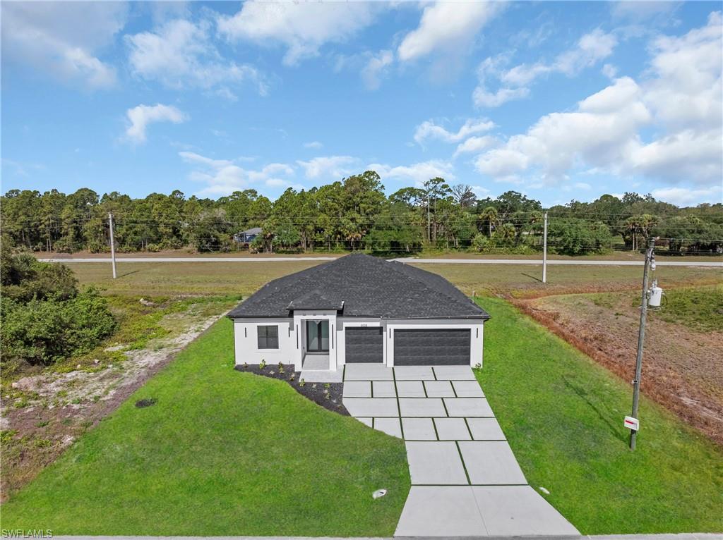 Motivated seller. Builder is offering up to $15,000 toward closing costs.  Welcome to this MASSIVE over 2,121 SQFT home.  This impressive floor plan spotlights GRAND elevations with admirable 8ft double entrance, 4 spacious bedrooms with generous Walk-In closets, 3 luxurious bathrooms HIGH ceilings with enhancing trays.  The spacious primary suite offers a spa-inspired master bathroom complete with elegant rain shower, dual vanities, and premium details throughout. 8ft sliders with dual access out to the spacious back patio, an irrigation system. It also highlights exquisite porcelain tile throughout, IMPACT windows & doors.  The rewarding kitchen features an inviting breakfast bar, soft close shaker cabinets, high gloss kitchen, STAINLESS STEEL appliances, and a pantry.  Custom mirrors, laundry under air, fully equipped outdoor kitchen, and a rare 3 car garage, Greenbelt and NOT in a flood zone. Schedule your showing today!