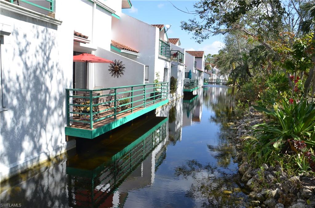A community like no other in Naples - a must see.  Lush Nature Trail and every balcony/deck overhanging water.   On a tropical landscaped lagoon with private deck.  First floor end unit with attached garage.  Hurricane shutters.  Kitchen with granite counter tops and an adjacent breakfast room.  Soaking tub and dual sinks in the master.  Sun room and dining room offer flexibility. Resort style pool & spa.  Gulf access from the boat docks and a kayak/canoe rack.  A short walk or bike ride to  the Greenway, which connects North to the Conservancy/Zoo and South to the projected  Baker Park and Olde Naples.  Only minutes by car to 5th Avenue.  All dimensions and information are provided by third party sources, are approximate and should be verified by the buyer