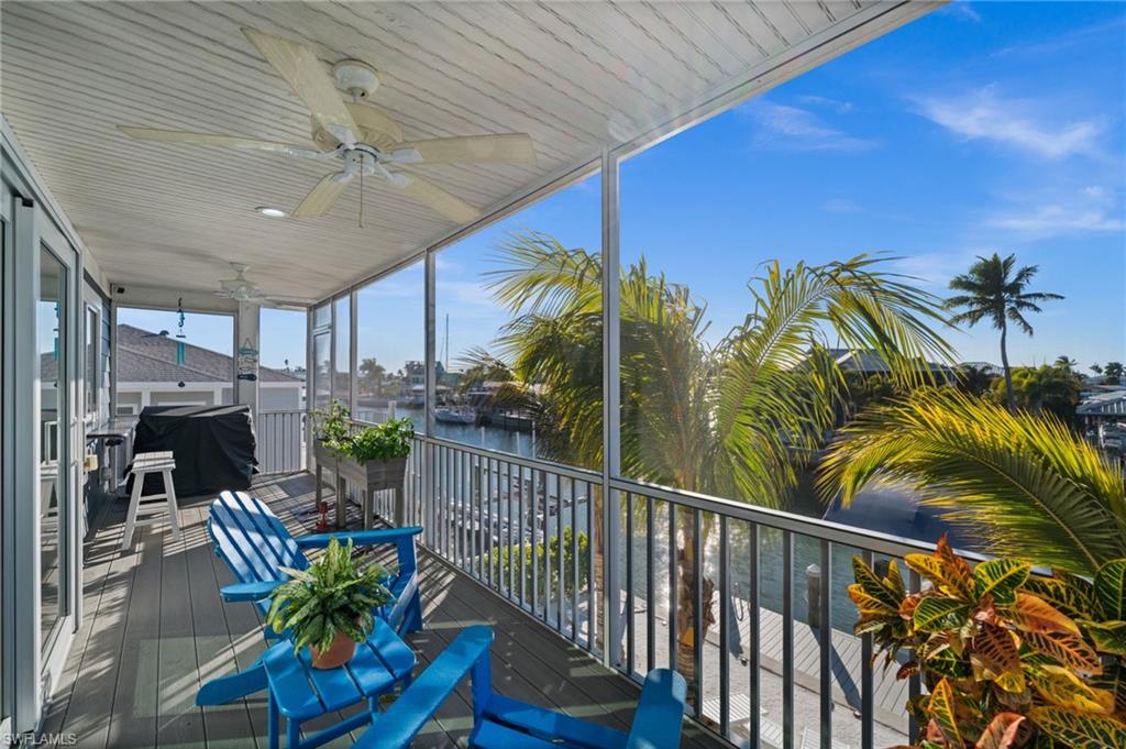 Built to last and designed for the waterfront lifestyle, this custom 2018 Insulated Concrete Form (ICF) home combines exceptional strength, energy efficiency, and storm resilience with quick, deep, direct access to the Gulf of America. Offering 3 bedrooms, 2.5 baths, and quality construction rarely found on the island, this home features impact windows and doors, a standing seam metal roof, and solid ICF construction for outstanding durability and peace of mind. The elevated second-floor living area is designed to maximize breathtaking intersecting canal views and spectacular Southwest Florida sunsets. The open-concept great room flows seamlessly into the well-appointed kitchen featuring island seating, tile backsplash, stainless steel appliances, and a versatile flex space ideal for a home office, pantry, or hobby area. The primary suite offers private lanai access, a spacious en-suite bath with dual vanities, a walk-in shower with rain shower feature, and generous closet space, while a convenient half bath completes the main living level. The first floor provides two spacious guest bedrooms, a full guest bath, an in-residence laundry area, and an oversized two-car garage with a rear overhead door for easy access to your boating equipment and waterfront toys. A paver driveway offers plenty of parking for family and guests. Outside, the waterfront setting is ready for relaxing or entertaining with a patio, beach-style lounging area, freestanding hot tub, and room to add a custom pool. The 2017 seawall, composite dock, and 10,000-pound covered boat lift make getting on the water quick and effortless. From here, enjoy easy, deep-water boating with direct access to the Gulf of America, world-class fishing, nearby barrier islands, waterfront restaurants, and endless days exploring Southwest Florida by boat. Whether you're searching for a full-time residence, seasonal escape, or weekend waterfront retreat, this home delivers exceptional construction, low-maintenance living, and the boating lifestyle you've been dreaming of.