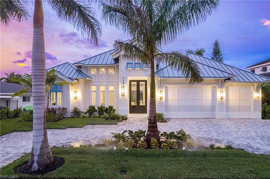 This Coastal Charmer has exquisite architecture and beautiful details throughout. Welcome home as you enter through stunning 12 ft front doors, Open plan with high ceilings & ceiling details including beams, woodwork and coffered finishes. Lavish kitchen with handmade white & oak cabinetry, opulent quartz countertops, wine refrigerator, top of line appliances, natural European oak floors, family room has stunning vapor fireplace & open ceiling details, custom double slider doors open to convenient office/den, owner's suite with large sitting area and coffered details, ensuite will not disappoint with soaking tub, generous shower and sizeable custom closets, your guests can escape the mundane in the guest suite with direct access to pool and private pool shower, all bedrooms have ensuite baths. Luxury pool has stunning built in firepit, waterfall designs, luxury spa and lounge area. Lanai is the perfect outdoor entertaining space, has retractable screens & hurricane shutters, fireplace and kitchen area. Just minutes from 5th Avenue & the private Moorings white sandy beach access. Not a mandatory flood zone no flood Ins. required. This site not effected by hurricane Ian.