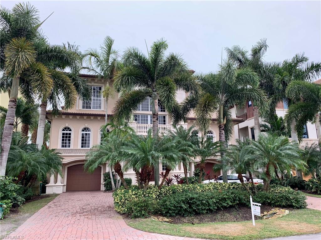 Southern exposure three-story four-bedroom suite plus office home on Vanderbilt Bay with deep water dockage overlooking the Ritz-Carlton beach resort. Check out the impressive French doors, open air balconies and patios, and chiseled edged Travertine carefully laid throughout the home and even the entire garage! This beauty has hurricane impact resistant glass/doors and a private elevator! Or if you want the exercise, you can always climb up the sweeping winding staircase that accentuates and further beautifies your foyer upon entry. Enjoy a dual two-car tiled garages that might well be able to house more than four vehicles -- plus extra storage space! First floor entertaining area opens up to oversized pool and deck area overlooking those views, views, views! And of course you can quickly zip out to the gulf from your private dock with lift for a day of leisure or waterfront dining ....