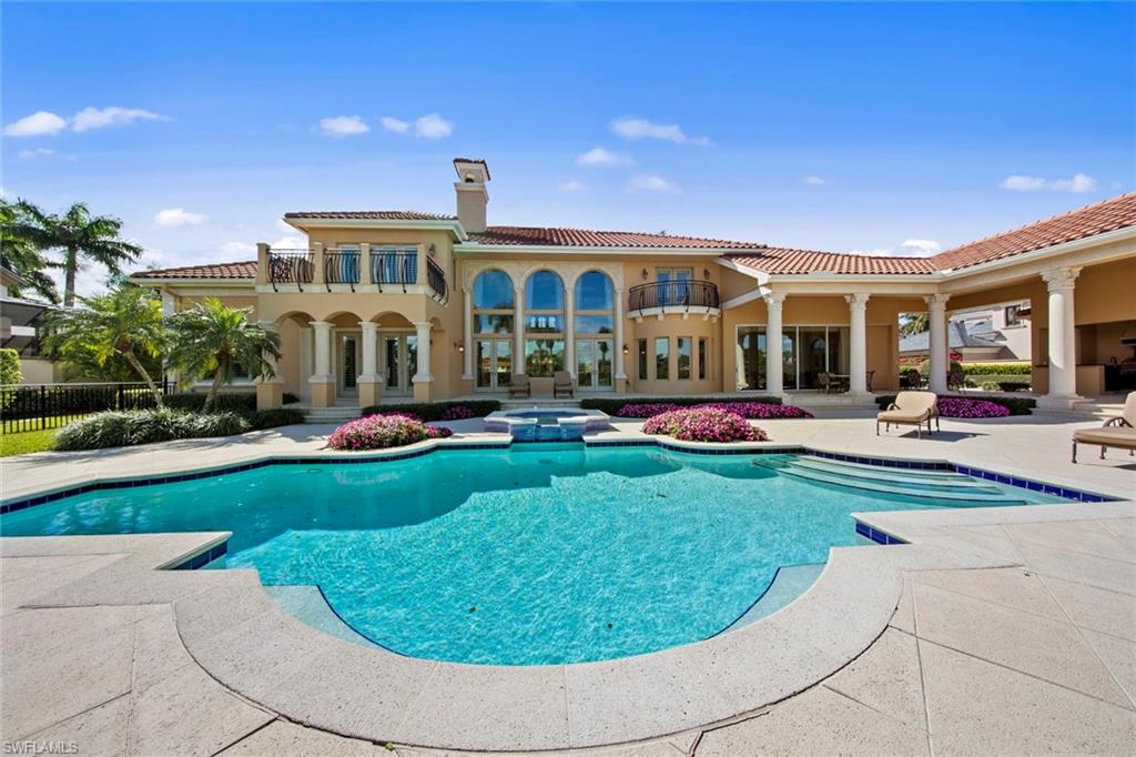 This vibrant and luxurious estate home in the very private Estates at Bay Colony Golf Club is nestled among an enclave of 75 estate homes, with membership to the exclusive Bay Colony Beach Club included. Situated on a cul-de-sac, this estate home rests on the 1st hole of the championship course and enjoys a beautiful northeastern exposure from the private backyard. The home boasts four bedrooms and a den, five full bathrooms, two half baths, formal living and dining room, spacious kitchen, outdoor kitchen, gas fireplace, detached guest suite, and spacious master suite. A three-car garage with a separate golf cart garage are accessed by the second driveway. Gorgeous landscaping throughout the property gives a colorful and extravagant feel from both the road and your lanai. Upstairs you will find 2 en-suite bedrooms, a wet bar, a second living area along with a balcony overlooking the pool, spa, and golf course!