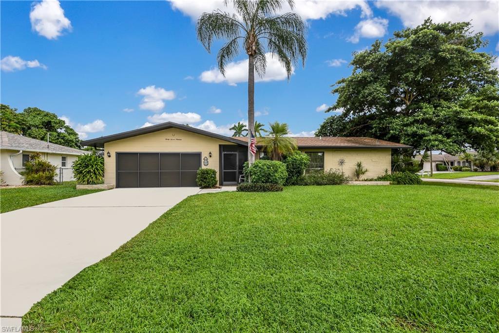 Unique Cape Coral property on oversized corner lot! This single family home is situated in a highly desired, well-established S Cape Coral non-gated neighborhood and features driveways on two roads both leading to independent 2-car garages- one w/ screen door and one used as a mechanic shop & has built in cabinets/storage. The interior of the home offers a wonderful layout w/ a living & family room, screened front entry, wide galley style kitchen w/ breakfast bar & pantry, formal dining room, split bedroom floor plan, and a Florida room w/ brand new laminate flooring. You will love spending time on the open lanai in the fully fenced-in backyard that also offers a fire pit area. Meticulously maintained & updated home- new range & microwave in 2014; new dishwasher, freshly painted interior/exterior, new washer/dryer in 2015; new a/c in 2017; new hot water heater in 2018; new laminate flooring just laid in Florida room, plus the same flooring will be installed in the bedrooms; and continual updates to the landscaping. Only a short bike ride to downtown Cape Coral where you can catch the Nickel Ride or just enjoy the outdoor dining of many restaurants/bars.
