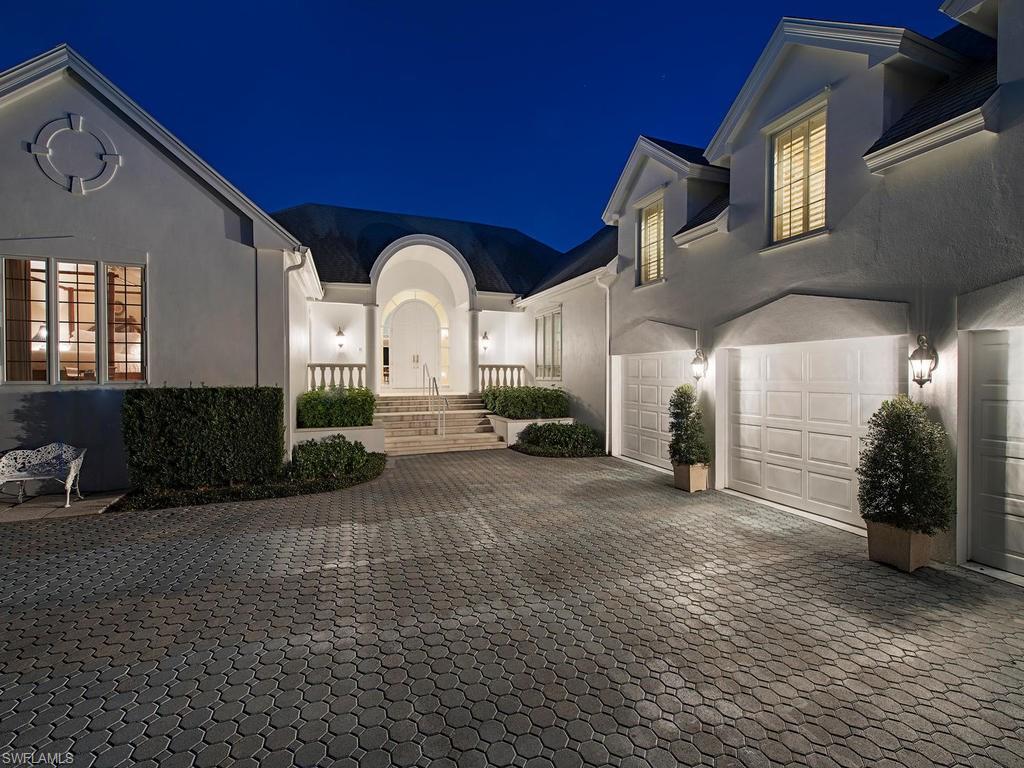 Stately Palm trees line Spyglass Lane, a cul-de-sac street with convenient access to Old Naples. The classic architecture of Bermuda provides only a clue to the many amenities this home offers. A delightful hallway with wooden flooring leads into this exceptional home. The view of Runaway Bay is enjoyed from the living room, sunroom, kitchen, breakfast room, family room and master bedroom. These open, airy rooms provide easy family living and exceptional areas for entertaining. A private dining room is conveniently located between the kitchen and wine closet. Two studies offer secluded areas for business, hobbies, etc. The master bedroom overlooks the water and spectacular early morning sunrises. Two bedrooms with private baths are located on the first floor in separate wings of this charming home. Two more bedrooms and baths provide secluded areas for guests. Air conditioned storage over the pantry and wine closet. The pleasure of a lanai for outdoor dining, entertaining, relaxing and watching the boats go by offers a peaceful respite.The private dock offers access to the Bay and Gulf. Port Royal Club Membership eligibility.