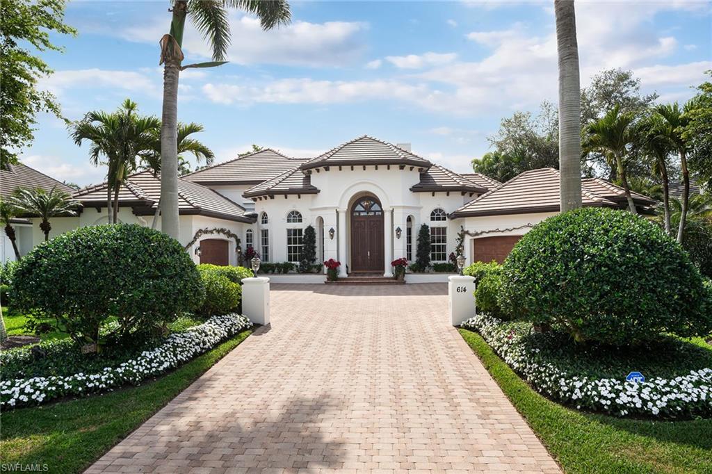 Located on a highly sought-after street in The Moorings and in the desirable X500 flood zone, this exceptional Mediterranean-style residence enjoys coveted southern exposure and abundant natural light throughout. The spacious two-story floor plan features a first-floor primary suite and guest suite, offering a comfortable and functional layout ideal for both everyday living and hosting guests. The expansive chef’s kitchen is designed for gathering and entertaining, featuring gas cooking, double islands with breakfast bar seating, abundant cabinetry and a generous pantry. The kitchen opens seamlessly to the main living areas, creating a natural flow for relaxed living and entertaining. The primary suite serves as a private retreat with a spacious spa-inspired bath offering dual vanities, a soaking tub and separate walk-in shower. Outdoor living is equally impressive, highlighted by a large pool and spa with expansive sunshelf and a fully equipped outdoor kitchen—perfect for enjoying the Naples lifestyle year-round. A rare four-car garage with room for lifts makes this property especially appealing for car enthusiasts or collectors. Ideally located just minutes from The Moorings private resident beach and the renowned dining, shopping and cultural destinations of Downtown Naples.  Roof was replaced in 2023.