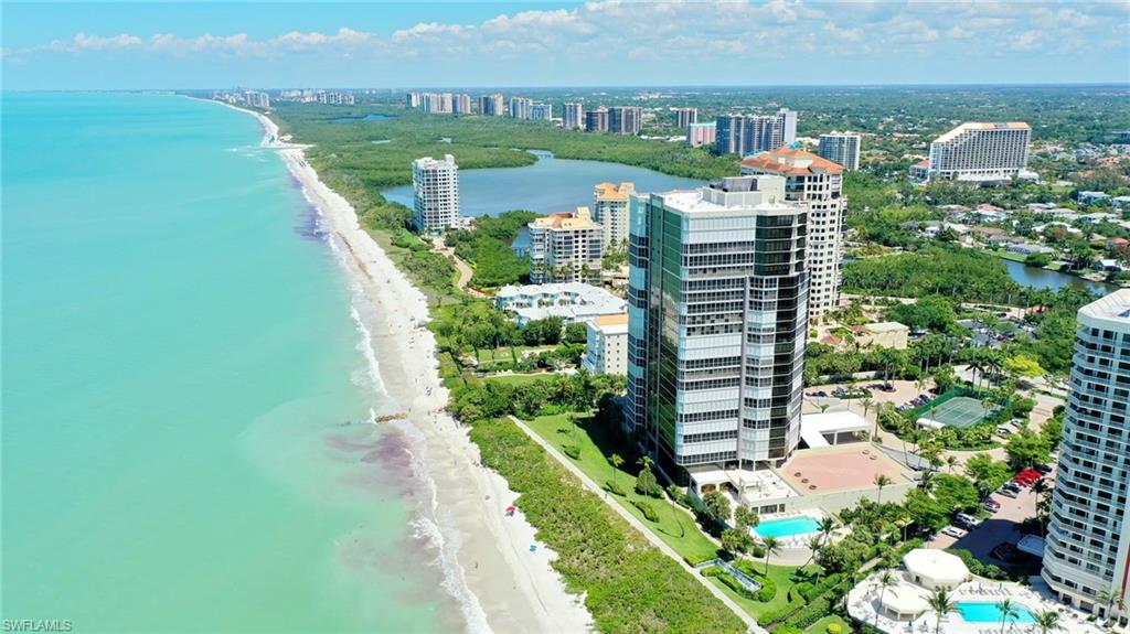 Located at the Northern point of Park Shore Beach this luxury building exudes elegance and privacy. Original owners, this custom open floor plan is filled with natural light from the 9ft. floor to ceiling windows and along the West facing terraces. Both terraces are glassed with sliders that provide the ultimate all-weather, year-round enjoyment. Electric shutters. Three bedroom and den are all direct beachfront, with 3 bathrooms and powder bath. Temperature controlled wine closet ready to be personalized. Spacious interior storage. Le Parc offers a gated, walled entrance, 24 hour security and on-site manager. There is a spectacular 2-story lobby, a modern workout facility, har-tru tennis, and a beachfront heated pool and spa. 2 guest suites. New pool lounge area will include a second story, beach view area to enjoy direct gulf views. Pet friendly. Semi-private apartment entry with only 4 units per floor (2 penthouse) with 2 on each side of building. 2 deeded parking spaces under building and building bike storage and beach gear storage. Active social calendar and part of the Blue Zone healthy living community.Boat slips available to purchase/lease on Venetian Bay.