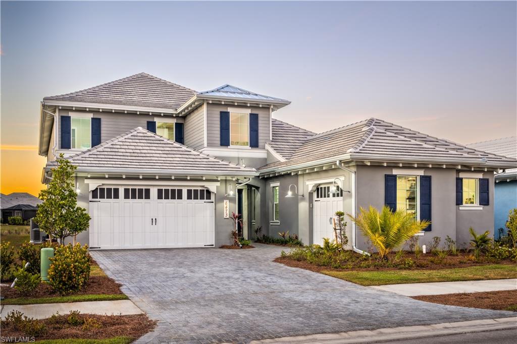 JUST COMPLETED 2022 new construction, barely lived in, coastal luxury home in highly desirable Isles of Collier Preserve. Largest floorpan built in ICP. Western exposure provides endless sunsets from the private second-story balcony and the multiple outdoor living spaces overlooking the resort-style pool and spa. Enjoy sweeping lake views from nearly every room of the expansive residence. Entertaining is a breeze with chef's kitchen, large island, outdoor kitchen, massive laundry room, split bedrooms, upstairs living area and guest suite with private balcony. At days end you can escape to your private master suite with sitting area and spa like bathroom. Residence is finished with soaring ceilings, beautiful hardwood flooring, den and a three car garage.  Builder's warranty is still in place until September 2023. The Isles of Collier Preserve is a gated community with amenities including, pickleball, tennis, kayaking, enormous fitness center, lap and resort pools, Key West style Bar and grill, over 8 miles of walking trails, and is located less than five miles to the beach and just minutes to downtown 5th Avenue!