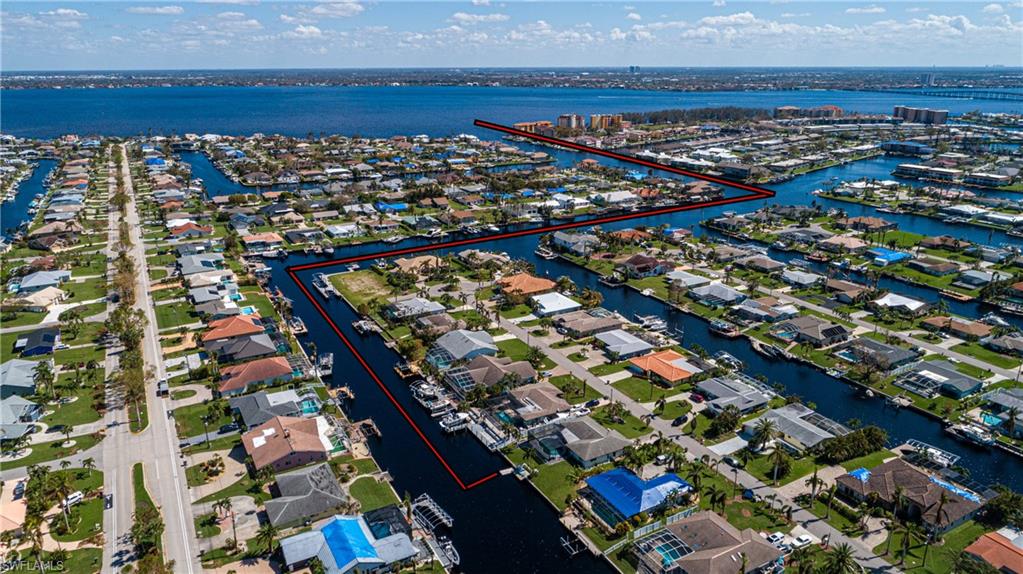 HUGE PRICE REDUCTION! BRAND NEW ROOF 2023! Direct Sailboat Gulf Access No Bridges! Less than 5 minutes to the river by boat! NO FLOOD ZONE! Welcome into this beautifully designed and exquisite open concept home. The moment you walk into the double door entry, you are warmed by the modern open floor plan, color scheme, rich wood flooring and glorious natural light. The kitchen offers updated grey cabinets, farm sink, open wood shelving, stainless steel appliances, breakfast bar and quartz countertops. The layout is perfect for entertaining. Large quartz island is open to your living area with floor to ceiling windows, fireplace and custom rustic wood mantel and shelving. A true split bedroom floor plan gives you the master oasis you have always wanted with custom accent walls. Sliders to the lanai and pool, highlighted with a modern spa bathroom. The opposite side of the home boasts 2 more bedrooms, laundry room and pool bath. Stunning views to your outside living space and canal are available from the main rooms of home. Relax outdoors in your picture framed screened paver stone lanai with a recently remodeled built in pool overlooking the gulf access canal.
