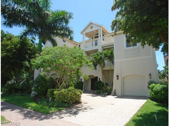 Magnificent 3-story Barefoot Beach home!  Features of this fine residence include, 4-car garage, 4 bedrooms plus den, 4 full and 1 half bath, private elevator, impact windows, concrete construction, stunning tile and wood flooring throughout, central vacuum, security system, fireplace and volume ceilings. The second floor features two large guest bedrooms each with private baths, laundry room for guests, family room, formal living room & kitchen.  The kitchen features large island with prep sink, gas cooktop & a breakfast room with ocean views. The third floor includes a laundry room designated to that floor, a guest bedroom and office/den area with built in wetbar, mini fridge and Miele coffee maker. Also on the third floor is the master suite that features a spacious sitting area, 2 huge walk-in closets, bidet, seperate jacuzzi tub large double entry walk-in shower with 3 shower heads.  Incredible Gulf & sunset views!