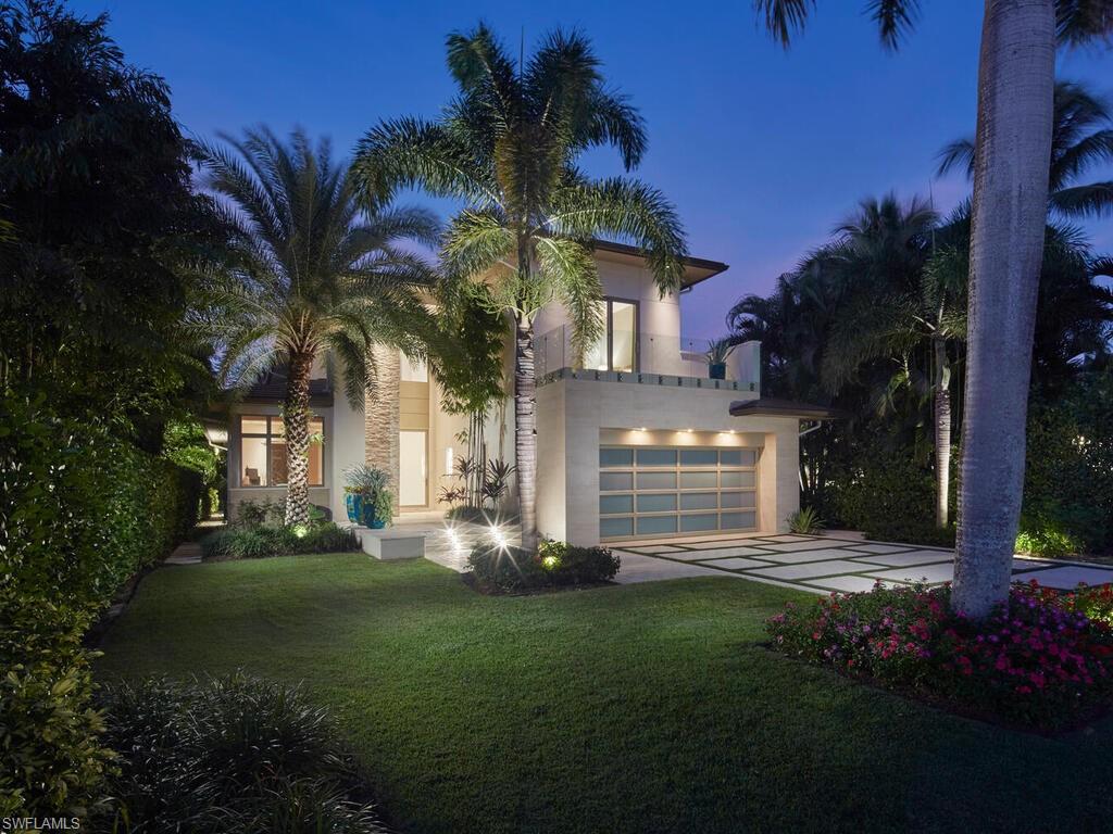 Nestled in the heart of Old Naples, just three blocks from the beach and steps away from world-class shopping and dining on 5th Avenue and 3rd St South, this custom, newly built London Bay home is ideally located on a peaceful street. The open floor plan showcases luxurious finishes and attention to detail throughout. The spacious kitchen features a 13-foot island and an expansive walk-through pantry, complemented by rift oak and high-gloss white cabinetry that harmonizes beautifully with the wide plank oak floors. An open formal dining room and expansive great room with a bar flow effortlessly through pocketing sliding glass doors to a covered outdoor living area. This outdoor oasis includes a fireplace, an outdoor kitchen, automated screens, pool, a tranquil pond and water feature, and a beautifully designed private garden shower. The second floor is home to two guest suites, a comfortable bonus room, and the primary suite, which boasts two walk-in closets and a private balcony overlooking the tropical yard. Additional noteworthy features include a 3-car garage, an elevated generator, air-conditioning units, and tankless water heaters, all with the convenience of natural gas serving the property.