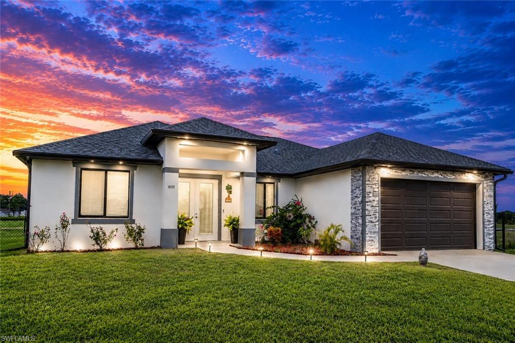 2022 CONSTRUCTION – MOVE-IN READY – FULLY FENCED BACKYARD – IMPACT WINDOWS & DOORS - PEACEFUL LABELLE LIVING! Welcome to 7035 Brazil Circle in beautiful LaBelle, where modern design, quality construction, and quiet Florida living come together in this exceptional move-in-ready home. Featuring 3 bedrooms, 2 bathrooms, and a spacious 2-car garage across 1,557 square feet, this home is ideal for first-time buyers, retirees, or anyone looking for comfort, style, and convenience without the wait of new construction. From the moment you arrive, the curb appeal sets the tone with elegant stone-accented garage trim and a striking 8-foot double-door entry. Inside, you’re welcomed by soaring 9’3” ceilings, tray ceilings in the main living areas, 8-foot interior doors, 4-inch baseboards, and sleek 24x24 porcelain tile flooring throughout—no carpet anywhere. The chef-inspired kitchen is designed for both everyday living and entertaining, featuring quartz countertops, a large center island with breakfast bar seating, stainless steel appliances, 42-inch custom soft-close cabinetry with crown molding, and generous storage. The split-bedroom floor plan provides privacy, while the spacious owner’s suite offers a true retreat with a large walk-in closet, dual sinks, and a luxury walk-in shower with floor-to-ceiling tile. Upgrades throughout include impact-resistant windows and doors, recessed lighting, ceiling fans in every room, a reverse osmosis water system, and a garage side-entry door. The home is truly move-in ready and includes a washer and dryer for added convenience. Step outside to an extended under-truss lanai with an exterior kitchen hookup already in place -- perfect for future outdoor living. The fully fenced backyard offers privacy (including safety for pets) and space to create your dream pool, garden, or entertaining oasis. Located outside the city limits of LaBelle, this home delivers peaceful surroundings while still offering quick access to schools, shopping, dining, Aldi, Walmart, and everyday conveniences. Don’t miss this opportunity to own a nearly new, upgraded home without the wait of construction delays. Schedule your private showing today—this one won’t last long! THIS PROPERTY QUALIFIES FOR A 1% LENDER INCENTIVE IF USING PREFERRED LENDER—INQUIRE FOR DETAILS. (Third bedroom has been virtually staged)