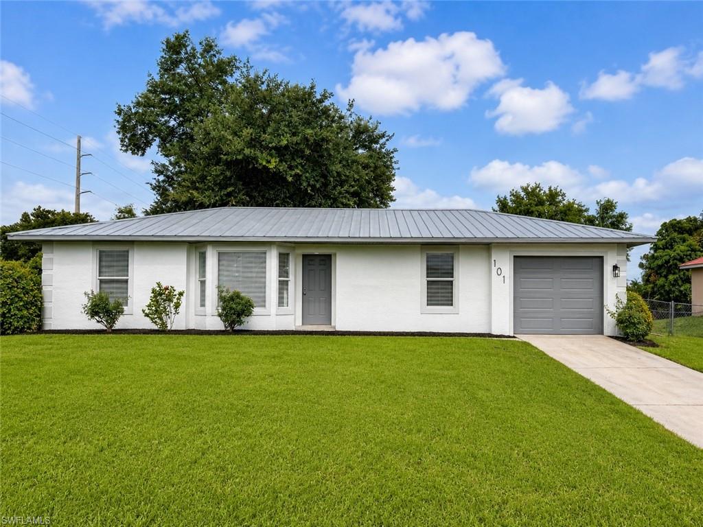 Newly refinished 3 bedroom 2 bath with a FENCED IN OVERSIZED BACKYARD WITH OAK TREES FOR SHADE, excellent for entertaining and parties, great views of the wildlife in the canal, fish from your backyard, METAL ROOF IN EXCELLENT LIKE NEW CONDITION- SEE ATTACHMENT IN MLS, NEW WATER HEATER IN 2022, NEWER LENNOX CENTRAL HEAT AND AIR IN 2017, NEW SEPTIC DRAINFIELD IN 2026, NEW KTCHEN AND BATHROOMS, solid surface stone countertops in kitchen with subway tile backsplash, newer cabinets, pantry, built in wine rack, eat in nook area, all kitchen appliances, new LED lighting throughout, ceramic tile floors with real wood WALNUT floors in the bedrooms, new five inch baseboards throughout, decorative molding in formal dining room with chair rail molding in the living room, French doors lead to the backyard, newly remodeled bathrooms with vessel sinks in both bathrooms, new vanities, mirrors, toilets, lighting and new oversized tiled shower in the primary bathroom, freshly painted inside and out, new stucco on the exterior, new garage door and opener, excellent location in WEST LEHIGH just minutes to I-75, Ft Myers and the SWFL International Airport. NO FLOOD INSURANCE REQUIRED. LEHIGH IS THE HIGHEST ELEVATION IN LEE COUNTY.