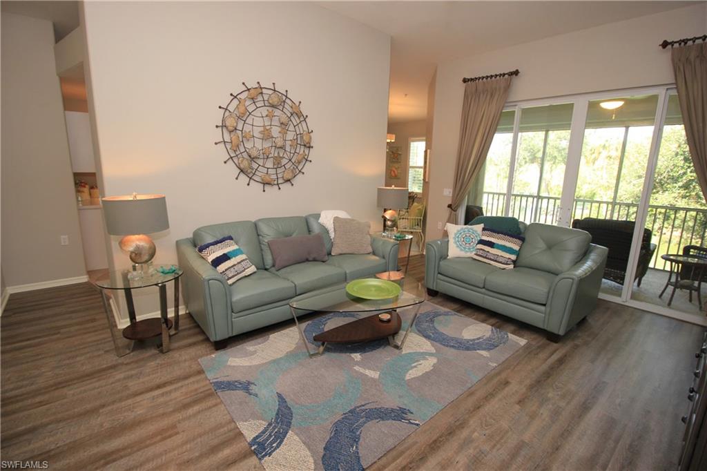 Free Golf Membership for remainder of 2019...NEW PRICE REDUCED! Amazing Golf course view from this 2nd Floor, 2 Car garage Coach Home. Open floor plan terrific for entertaining with updated flooring in living areas. Balcony view includes a water feature. Electric roll down shutter offers additional protection for  screened balcony.  Amenities include heated resort pool with spa, bundled golf, restaurant, fitness center, lap pool, pro shop, tennis courts, bocce court, pickle ball and driving range. Resort South Florida living at it's finest, conveniently located to SWF Airport, great shopping, restaurants and sandy beaches. Cypress Woods Golf and Country Club offers More information available @ http://www.cypresswoodsgolf.com/  This fantastic golf community boasts 18 hole Gordon Lewis designed Golf course.