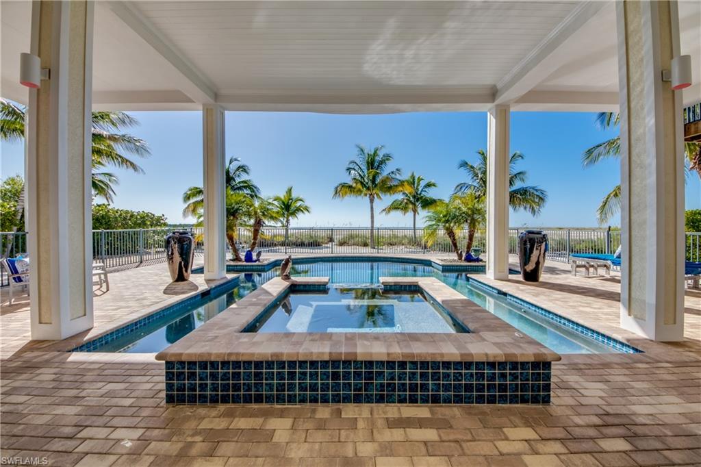 This Laguna Shores Beach House offers the perfect blend of comfort and elegance with an expansive stretch of private, sandy beach to call your own (1.8 Acres according to Deed & Survey). This home was developed by Windover Development, built by Potter Homes, and is situated in the prime location of the peaceful South tip of Estero Island with spectacular views of the Gulf... Lover's Key, Big Carlos Pass, and the Naples skyline. This design hosts an Open floor plan for indoor and outdoor living and dining with three EnSuite Bedrooms all on the main level. The entire upper level is reserved for the Owner's Suite and features a private entry, wet bar, sitting nook, office nook, luxury bath, and private balcony overlooking the estate. Step out back from the lower entry-level onto your resort-style pool and spa. Rest in the confidence of the fine quality found throughout... concrete pilings and siding; impact-resistant windows, doors, and sliders; choice hardwood & tile flooring, custom cabinetry, plantation shutters, electronic & automated screens & window treatments; and a private elevator serving all floors. Luxury, comfort, phenomenal views... it's all here and waiting for YOU.