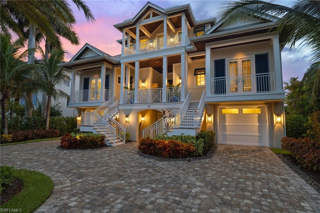 Few communities in SWFL rival Barefoot Beach's exclusivity. Brick-lined streets meander past the main guard house to the double-gated private enclave known as Southport on the Bay. 65 Southport offers unparalleled luxury at an unrivaled value, affording you the beach and boating lifestyle you desire and deserve. The community offers deeded beach access and the home has a private boat lift mere steps away in the Southport Yacht Club. Built by award-winning Potter Homes in 2018 with a complete interior design refresh in 2022 by Adelyn Charles Interiors, this home must be seen to be fully appreciated. The main living level features one VIP suite, two ensuite guest rooms, and the great room, which contains the living/dining room and kitchen. The kitchen is finely appointed with Thermador and Bosch appliances and premium finishes. The main living level also features a large, screened lanai with outdoor living space, grill, and dining area, all overlooking the pool, lake, back bay, and panoramic sunset views. Offering ultimate privacy, the primary suite encompasses the entire second living level and features a spa-like bathroom, two walk-in closets, morning bar, and an expansive screened lanai for your private enjoyment. The ground floor features a 6+ car garage, heated saltwater pool/spa, and a large covered and screened lanai. 65 Southport is centrally located, with world-class dining, shopping, and entertainment only a short drive away. Travel is a breeze with quick access to I-75 and both RSW and the Naples Airport. Detailed feature list available. You do not want to miss this opportunity; schedule your private sunset showing today.