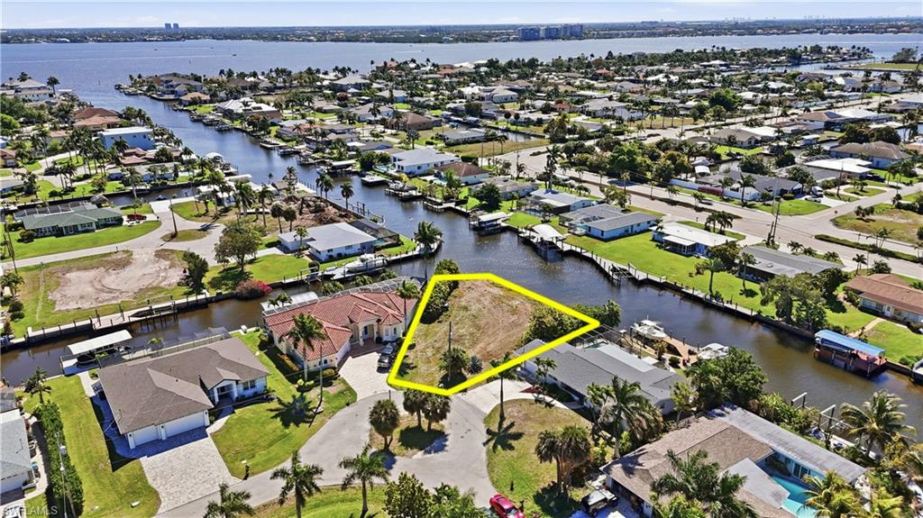 Build your dream home in the highly desirable Yacht Club area of Cape Coral. This southern exposure waterfront lot features approximately 145 feet of seawall and offers a short ride out to the river, making it ideal for boating enthusiasts. Conveniently located less than 2 miles from the Cape Coral Bridge and less than 1 mile from Downtown Cape Coral, this property combines waterfront living with easy access to restaurants, shopping, and entertainment. Added appeal comes from the ongoing Yacht Club Community Park revitalization, enhancing one of Cape Coral’s most iconic waterfront neighborhoods.  Seller has preliminary building plans that are available upon request.