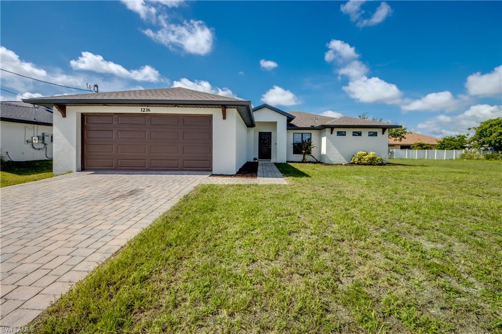 SOMETIMES THE SMARTEST MOVE ISN’T BUYING NEW—IT’S BUYING A HOME THAT STILL FEELS NEW. Built in 2020 by DB HOMES, this beautifully maintained ISLANDER MODEL delivers the modern design and finishes today’s buyers want while avoiding the wait, uncertainty and many of the additional costs that often come with new construction. One of the biggest advantages of buying a newer resale is that someone else has already invested thousands of dollars completing the details builders often leave to the homeowner. From the WHOLE-HOUSE GUTTERS, WINDOW TREATMENTS, LANDSCAPING, NEW INTERIOR PAINT to the other finishing touches throughout, you’ll enjoy those improvements from the day you move in. Whether you’re buying your first Florida home, downsizing into something easier to maintain or searching for the perfect seasonal retreat, this home was designed for the way people really live. The popular ISLANDER MODEL offers 3 BEDROOMS, 2 BATHS and a 2-CAR GARAGE with 1,723 square feet of comfortable living space beneath high CATHEDRAL CEILINGS. The split-bedroom floor plan creates privacy when you want it while the open living spaces naturally bring everyone together. Every home has a heartbeat and here it’s the kitchen! Morning coffee before the day begins, weeknight dinners, holiday baking or simply catching up with family all happen around the kitchen. You’ll enjoy timeless WHITE WOOD CABINETRY WITH CROWN MOLDING, GRANITE COUNTERS, STAINLESS STEEL APPLIANCES and the open design that keeps you connected to family and guests instead of separated from them. When it’s time to unwind, the PRIMARY SUITE becomes your own private retreat with a SPACIOUS WALK-IN CLOSET, DUAL SINKS and a TILED WALK-IN SHOWER WITH DUAL SHOWER HEADS. The INSIDE LAUNDRY includes WASHER AND DRYER, making this home truly move-in ready. The R-30 INSULATION helps improve year-round comfort and energy efficiency. HURRICANE SHUTTERS provide added peace of mind, while the AUTOMATIC SPRINKLER SYSTEM, WHOLE-HOUSE GUTTERS and fresh interior paint are improvements you won’t have to tackle after closing. Plus PAVERED driveway and covered lanai. Located in a NON-MANDATORY FLOOD ZONE, so NO FLOOD INSURANCE IS REQUIRED. NO PRIOR FLOODING OR STORM DAMAGE. LOCATION MATTERS and this NW Cape neighborhood continues to attract buyers looking for newer homes and room to breathe. Just minutes away you’ll find CORAL OAKS GOLF COURSE, an ARTHUR HILLS-DESIGNED 18-HOLE CHAMPIONSHIP PUBLIC COURSE, BURNT STORE MARINA BOAT RAMP for easy days on the water and the highly anticipated SEVEN ISLANDS waterfront district, bringing future dining, entertainment and recreation to one of Cape Coral’s fastest-growing areas. Some homes simply meet your needs. Others make it easy to imagine the life you’ll build there. Truly MOVE-IN READY, this 2020 DB HOMES ISLANDER MODEL offers the opportunity to spend less time on projects and more time enjoying everything Southwest Florida has to offer. Perhaps YOUR next chapter begins right HERE.