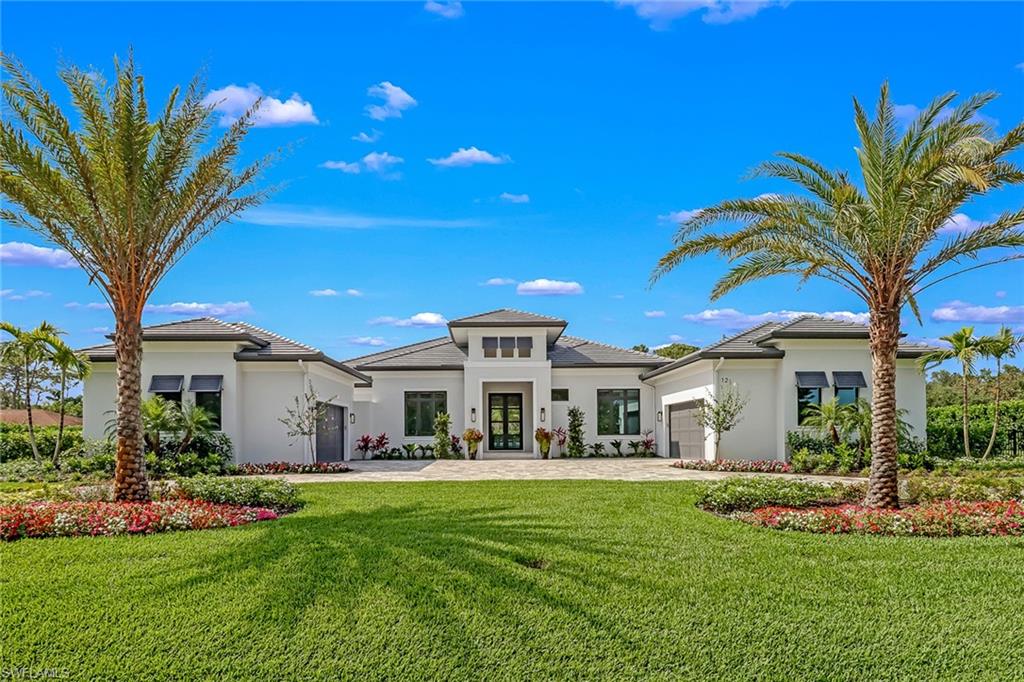 A single glance is all it takes to fall in love. Welcome to 12 Banyan—an exceptional estate offering over 4,500 square feet of refined living, where architectural elegance meets effortless comfort. A grand dual-entry driveway, lush tropical landscaping, and a freshly updated exterior set the tone for a striking arrival. Inside, award-winning interiors—curated with Clive Daniel furnishings and recipient of the 2022 Aurora Award for Best Interior Detailing—create a sophisticated yet inviting atmosphere. Soaring ceilings, expansive sightlines, and wide-format sliding glass doors flood the home with natural light while seamlessly blending indoor and outdoor living. Designed with both luxury and functionality in mind, the residence features two attached two-car garages, both air-conditioned—ideal for collectors, additional storage, or a climate-controlled workspace. Recent enhancements, including a freshly cleaned roof and newly sealed driveway, ensure a pristine presentation and added peace of mind. The home offers five spacious bedroom suites, each with a private full bath and generous walk-in closet. One suite serves as a versatile oversized great room, perfect for a media lounge, guest retreat, or multi-purpose living space. The primary suite is a true sanctuary, highlighted by dramatic windows, a private sitting area, dual walk-in closets, spa-inspired finishes, and a tranquil outdoor shower. Set on 1.15 acres, the property delivers ultimate privacy and a resort-style experience. Enjoy expansive covered outdoor living areas, a fully equipped outdoor kitchen and grill, and a private pool and spa overlooking a serene, lush landscape. A 1,000-gallon propane tank supports seamless outdoor entertaining. Ideally located less than five minutes from the beach and the Naples Ritz-Carlton resorts, and just moments from Waterside Shops, Mercato, and the vibrant dining, shopping, and entertainment of 5th Avenue South. Impeccably maintained and thoughtfully enhanced, 12 Banyan represents a rare opportunity to own a truly distinguished luxury residence.