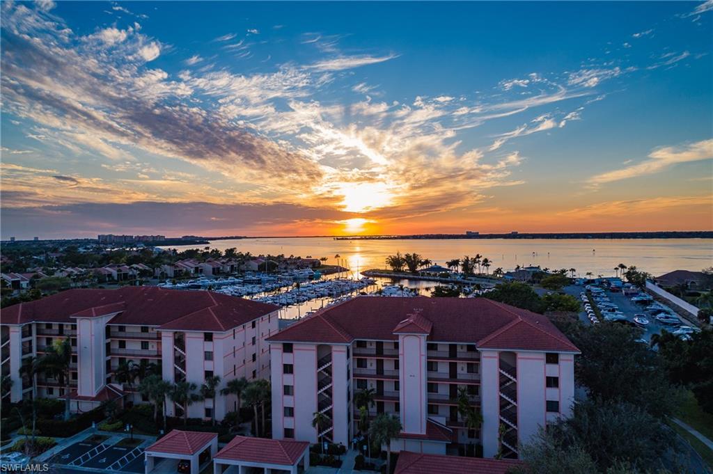 Gorgeous 3 br end unit with gorgeous view, right across from the marina!  You can see your boat from here, along with the river and amazing sunsets.  Completely updated kitchen with granite, new cabinetry, new appliances, new tile, all in coastal chic style.  Both baths are updated and beautiful, plantation window and sliding door treatments, new living room & bedroom carpeting and all new furniture too!  Being sold turnkey!  Covered parking spot and private storage closet.  Walk to the riverfront restaurant, picnic area and ship's store.  This gorgeous unit won't last long!!  Excellent location off McGregor and minutes to Ft Myers Beach, Sanibel, great shopping, theater, FLSW Univ, RSW airport, medical & downtown river district. The Landings Yacht Golf &Tennis Club is a highly active, gated community. Your monthly club fee INCLUDES AMENITIES of golf, tennis, pickleball, marina slips for up to 65' boat, waterfront picnic area & restaurant, clubhouse w/tavern, fitness center, heated resort & lap pool, & more. See why The Landings (on the banks of the Okeechobee Waterway) is SW FL's best kept secret!