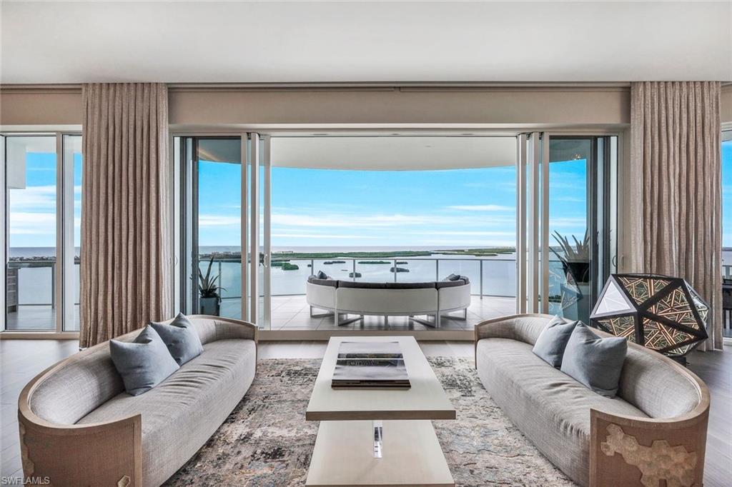 EXTREMELY SOUGHT-AFTER OMEGA 03 STACK WITH COTTAGE AND 3-CAR GARAGE boasting the highest ceilings in OMEGA, the 25th floor! This lavishly appointed Omega home will wow you the moment you enter its custom glass doors. Infinite non-obstructed views of the iconic Estero Bay & Gulf of Mexico, complete with private views of the preserve & golf course, you will understand why this position is coveted. Distinctive details are implemented. Stunning wood flooring, custom quartz countertops, Irpinia cabinetry, striking wall treatments, contemporary lighting, state-of-the-art sound system, & climate-controlled wine wall hosting up to 600 bottles. Spacious entertaining areas inside and out. Enjoy grilling on the wrap-around lanai where you never miss a sunset. The fully equipped cottage (over 800 sq ft) is a separate place where guests can enjoy privacy and lengthy stays. Omega incorporates ultra-modern design and amenities for its residents, including an open-air rooftop lounge with a fire pit, bar areas, & hot spas. In addition, Bonita Bay offers multiple opportunities for golf course membership, a marina, a beach club, & so much more.  Make this opulent home your next best address today!